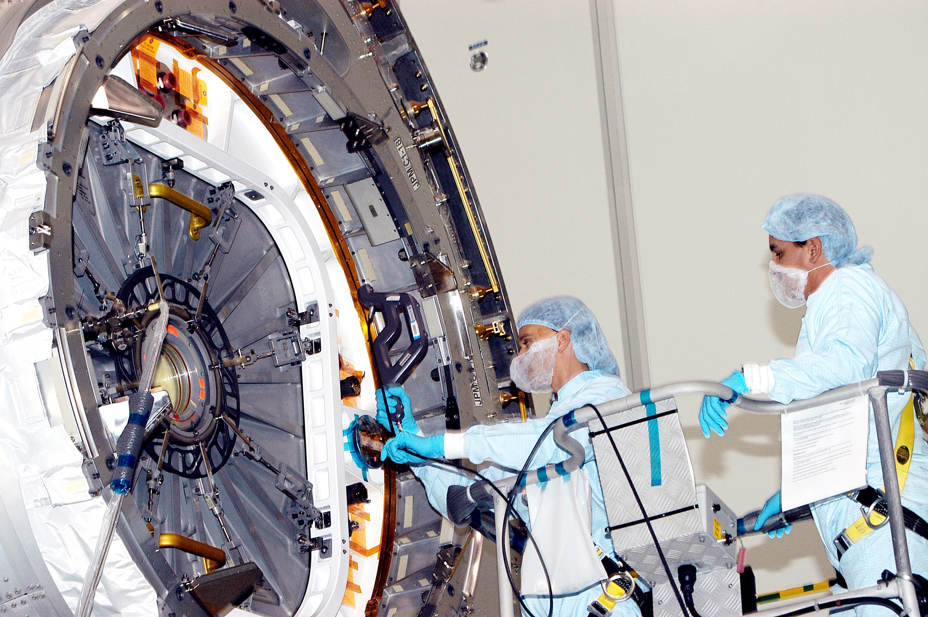 KENNEDY SPACE CENTER, FLA. - In the Space Station Processing Facility, technicians take readings for pre-assembly measurements on the Japanese Experiment Module (JEM). Developed by the Japan Aerospace Exploration Agency (JAXA), the JEM will enhance the unique research capabilities of the orbiting complex by providing an additional environment for astronauts to conduct science experiments.