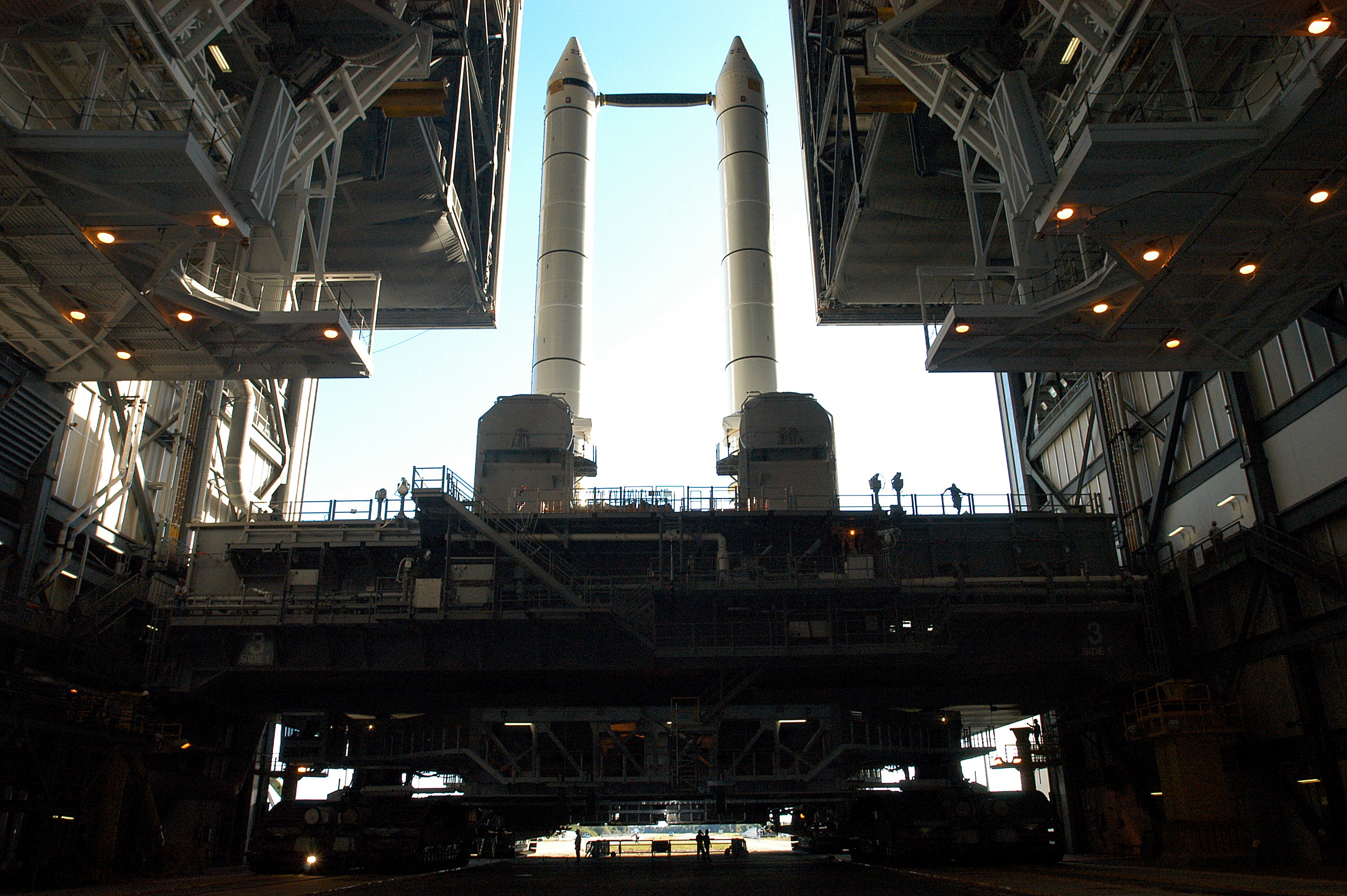 KENNEDY SPACE CENTER, FLA. - The crawler transporter is slowly moving the Mobile Launcher Platform (MLP), carrying a set of twin solid rocket boosters, out of the Vehicle Assembly Building (VAB) in support of engineering analysis vibration tests on the crawler and MLP. The crawler is moving at various speeds up to 1 mph in an effort to achieve vibration data gathering goals as it leaves the VAB and then returns. The boosters are braced at the top for stability. The primary purpose of these rollout tests is to gather data to develop future maintenance requirements on the transport equipment and the flight hardware. Various parts of the MLP and crawler transporter have been instrumented with vibration data collection equipment.