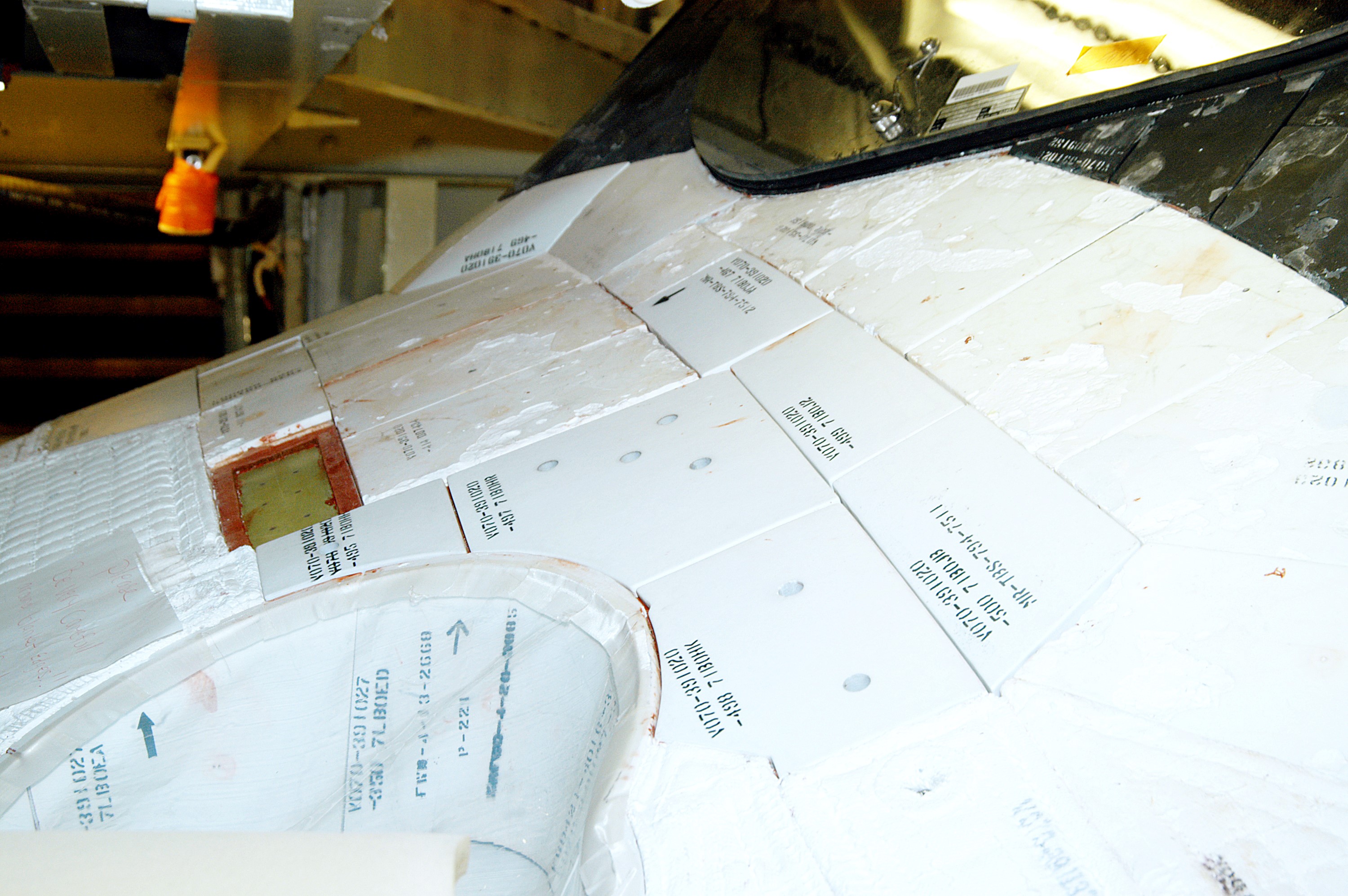 KENNEDY SPACE CENTER, FLA. - This view shows the tiles below the windshield on the orbiter Atlantis. A gap test is being performed on the tiles as part of return-to-flight activities. Atlantis is scheduled for mission STS-114, a return-to-flight test mission to the International Space Station.