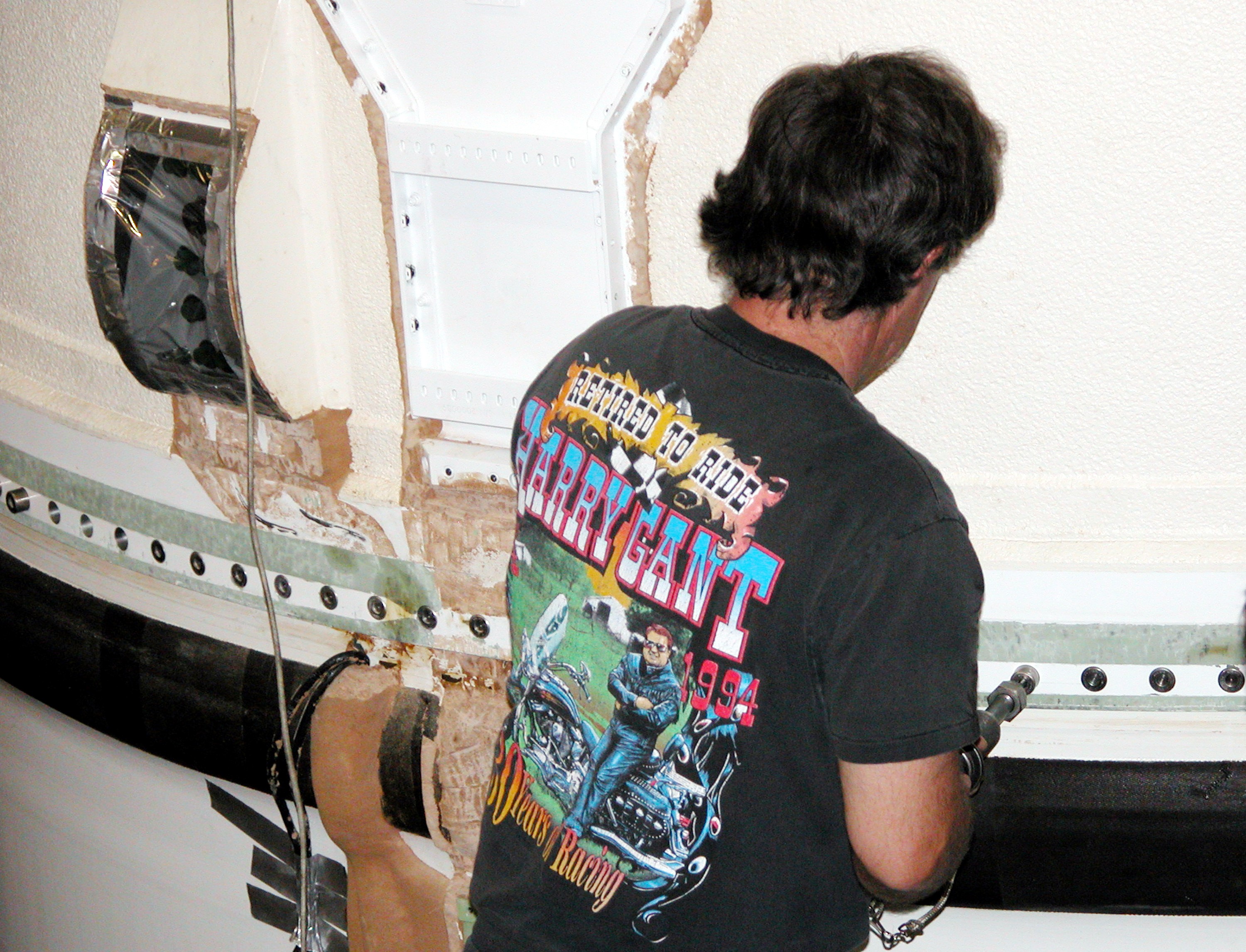 KENNEDY SPACE CENTER, FLA. - In the Vehicle Assembly Building, a KSC employee loosens a bolt on part of the forward assembly of a solid rocket booster (SRB) before destacking. The SRB was part of the stack on Atlantis originally scheduled for a March 1, 2003, launch on mission STS-114. The SRBs and external tank were demated in February 2003. The destacking is part of time and cycle activities. STS-114 is now scheduled to occur no earlier than Sept. 12, 2004, on Atlantis.