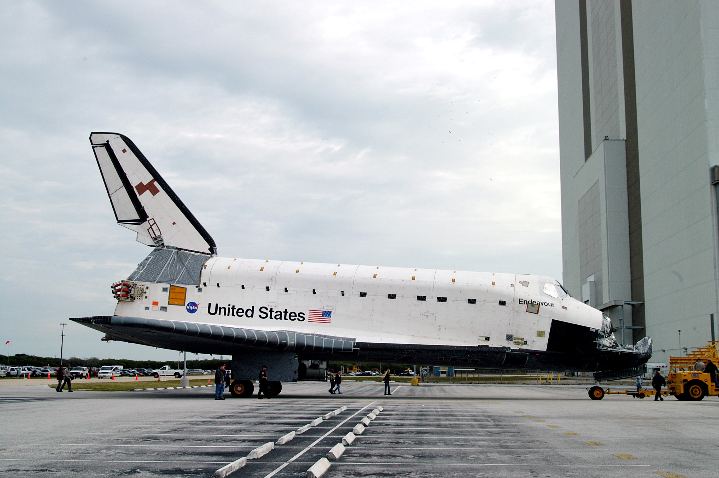 KENNEDY SPACE CENTER, FLA. -- Endeavour is towed in front of the Vehicle Assembly Building (VAB) where it is going for temporary storage. The orbiter has been moved from the Orbiter Processing Facility (OPF) to allow work to be performed in the OPF that can only be accomplished while the bay is empty. Work scheduled in the OPF includes annual validation of the bay’s cranes, work platforms, lifting mechanisms and jack stands. Endeavour will remain in the VAB for approximately 12 days, then return to the OPF.