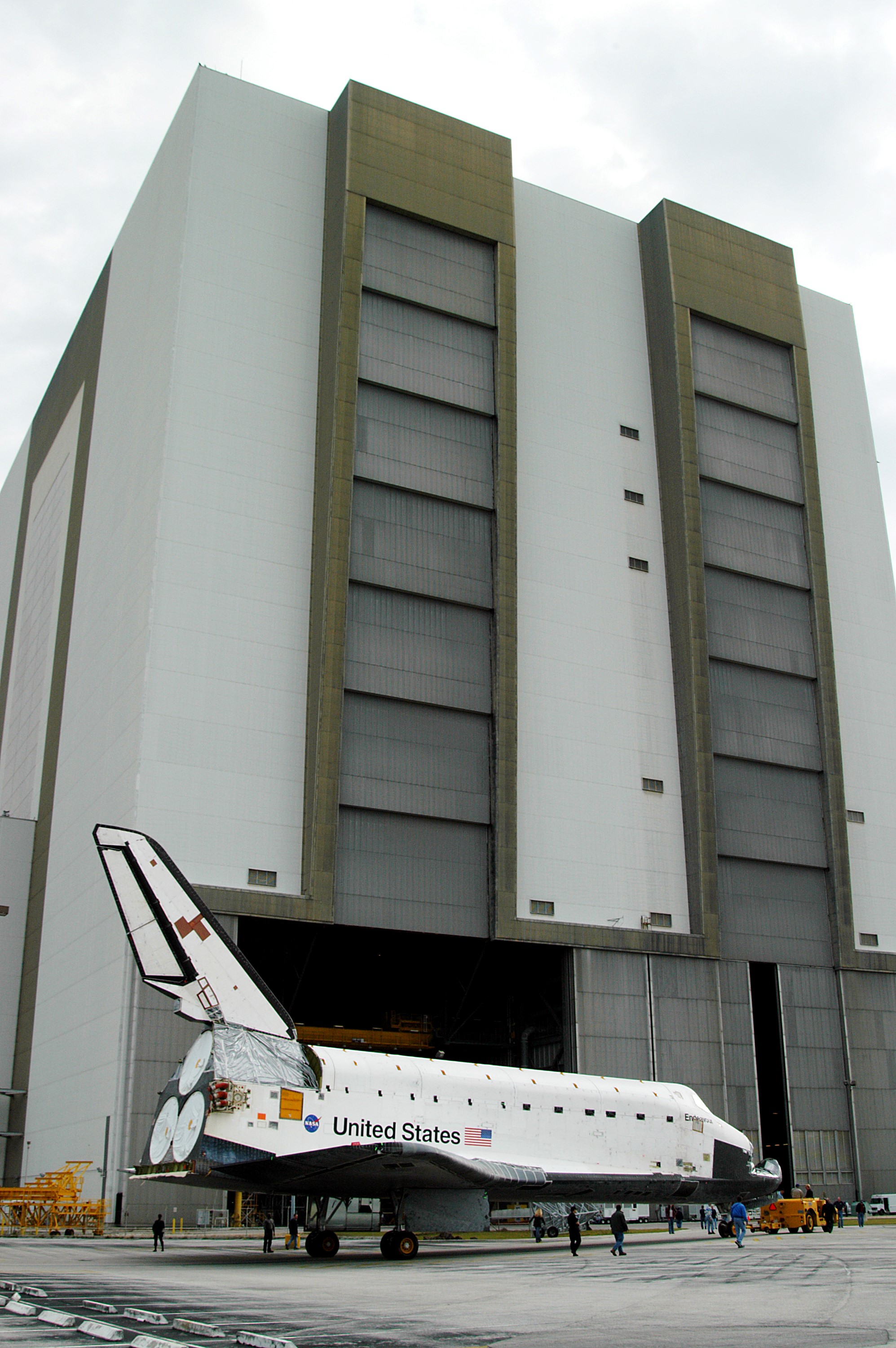 KENNEDY SPACE CENTER, FLA. -- Endeavour is towed in front of the Vehicle Assembly Building (VAB) where it is going for temporary storage. The orbiter has been moved from the Orbiter Processing Facility (OPF) to allow work to be performed in the OPF that can only be accomplished while the bay is empty. Work scheduled in the OPF includes annual validation of the bay’s cranes, work platforms, lifting mechanisms and jack stands. Endeavour will remain in the VAB for approximately 12 days, then return to the OPF.