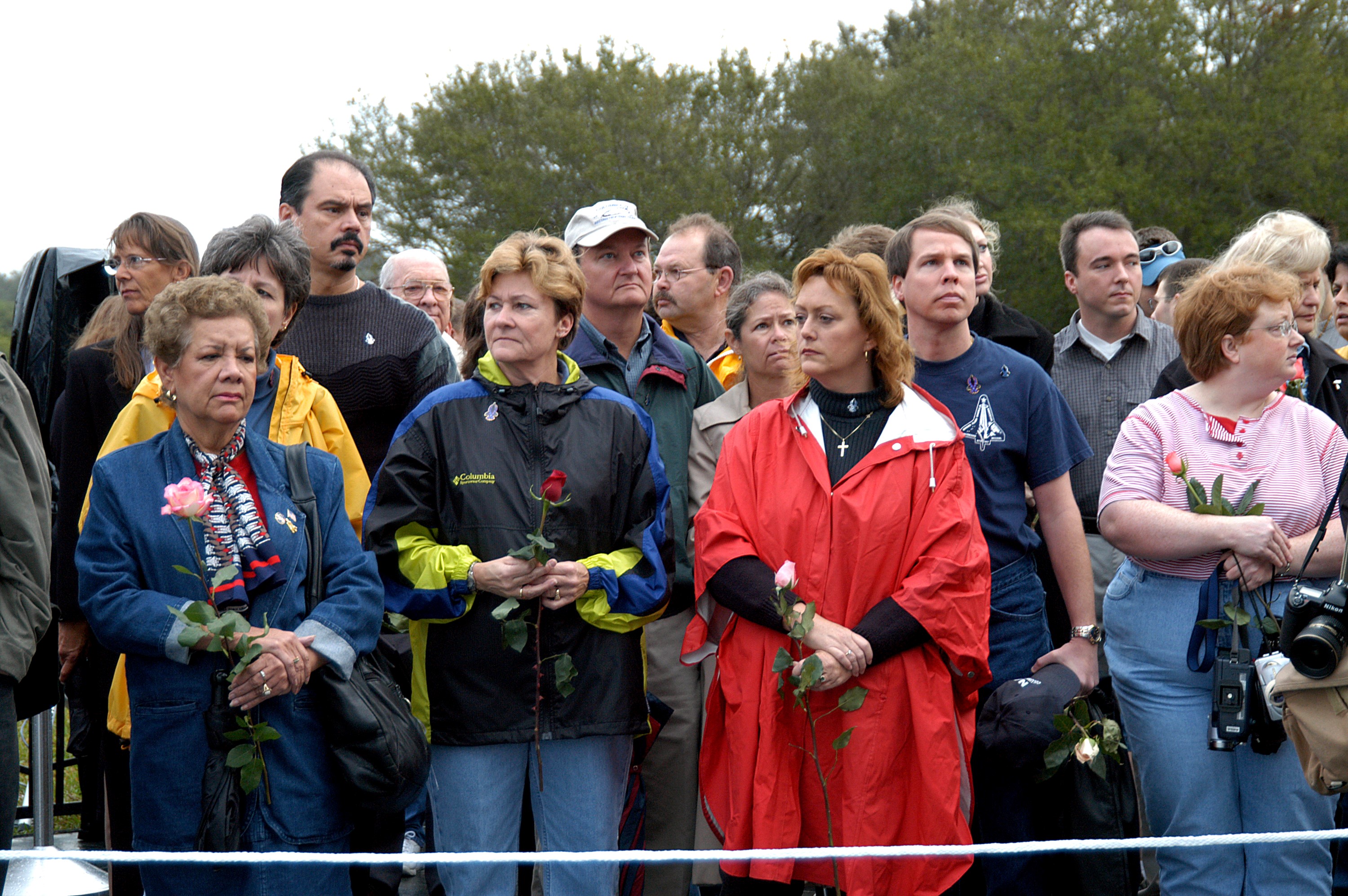 KENNEDY SPACE CENTER, FLA. - Friends, co-workers and families gather at the Space Memorial Mirror for KSC’s special service remembering and honoring the crew of Columbia. Feb. 1 is the one-year anniversary of the loss of the crew and orbiter Columbia in a tragic accident as the ship returned to Earth following mission STS-107. The public was invited to the memorial service held at the KSC Visitor Complex. Participants included Center Director Jim Kennedy, Deputy Director Woodrow Whitlow Jr., Executive Director of Florida Space Authority Winston Scott, Dr. Stephen Feldman, president of the Astronaut Memorial Foundation, and dancers from the Shoshone-Bannock Native American community in Fort Hall, Idaho.