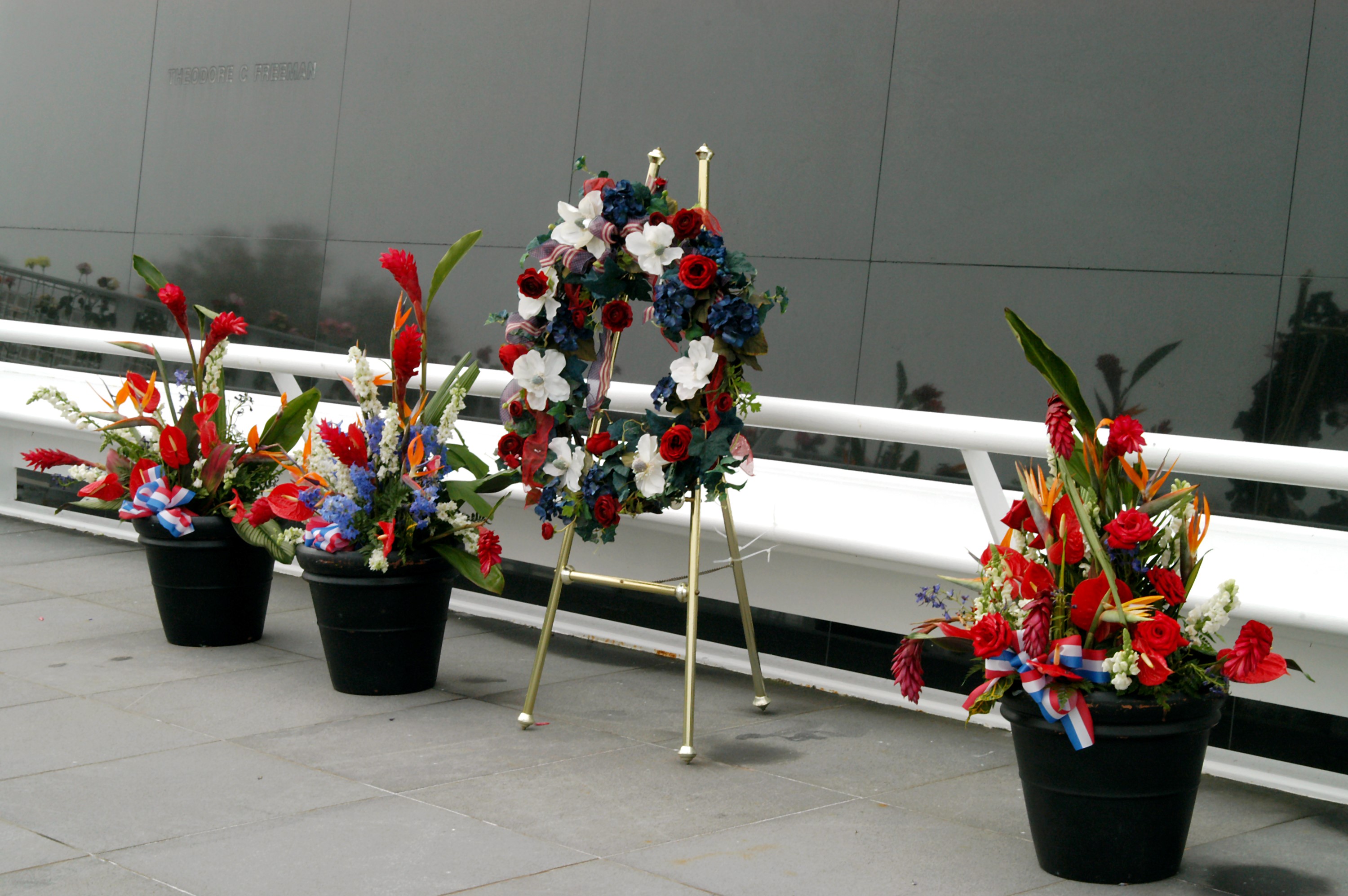 KENNEDY SPACE CENTER, FLA. - A wreath and other floral arrangements rest beneath the Astronaut Memorial Mirror at the KSC Visitor Complex following a memorial service held for the crew of Columbia on the anniversary of the tragic accident that took their lives Feb. 1, 2003. The service included comments by Center Director Jim Kennedy, Deputy Director Woodrow Whitlow Jr., Executive Director of Florida Space Authority Winston Scott, and Dr. Stephen Feldman, president of the Astronaut Memorial Foundation, who placed the wreath at the mirror. The black granite mirror honors astronauts, whose names are carved in the surface, who have given their lives for space exploration.