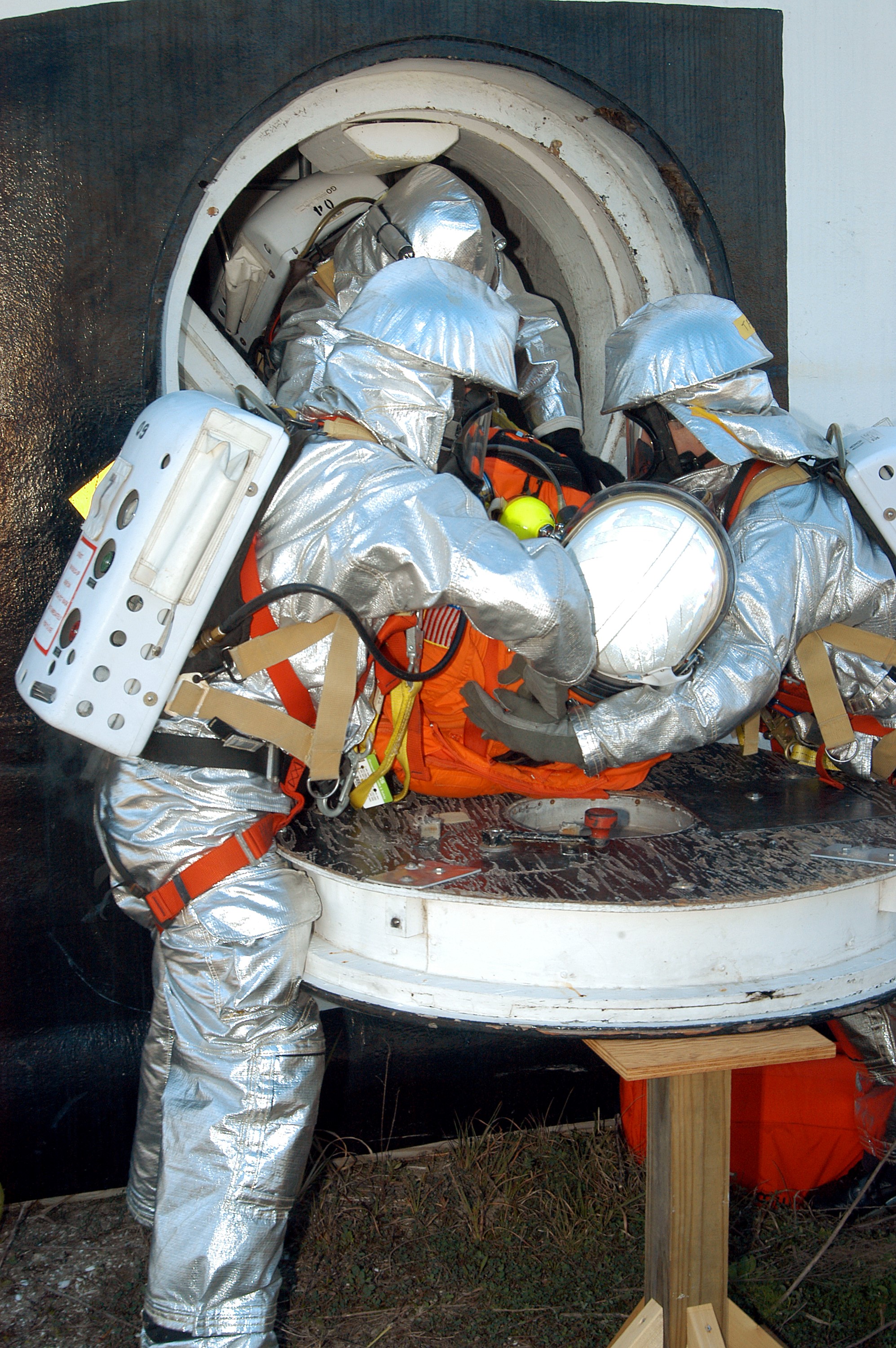 KENNEDY SPACE CENTER, FLA. - Emergency crew members “rescue” an injured astronaut from the orbiter crew compartment mock-up during a “Mode VII” emergency landing simulation at Kennedy Space Center. The purpose of the Mode VII is to exercise emergency preparedness personnel, equipment and facilities in rescuing astronauts from a downed orbiter and providing immediate medical attention. This simulation presents an orbiter that has crashed short of the Shuttle Landing Facility in a wooded area 2-1/2 miles south of Runway 33. Emergency crews are responding to the volunteer astronauts who are simulating various injuries. Rescuers must remove the crew, provide triage and transport to hospitals those who need further treatment. Local hospitals are participating in the exercise.