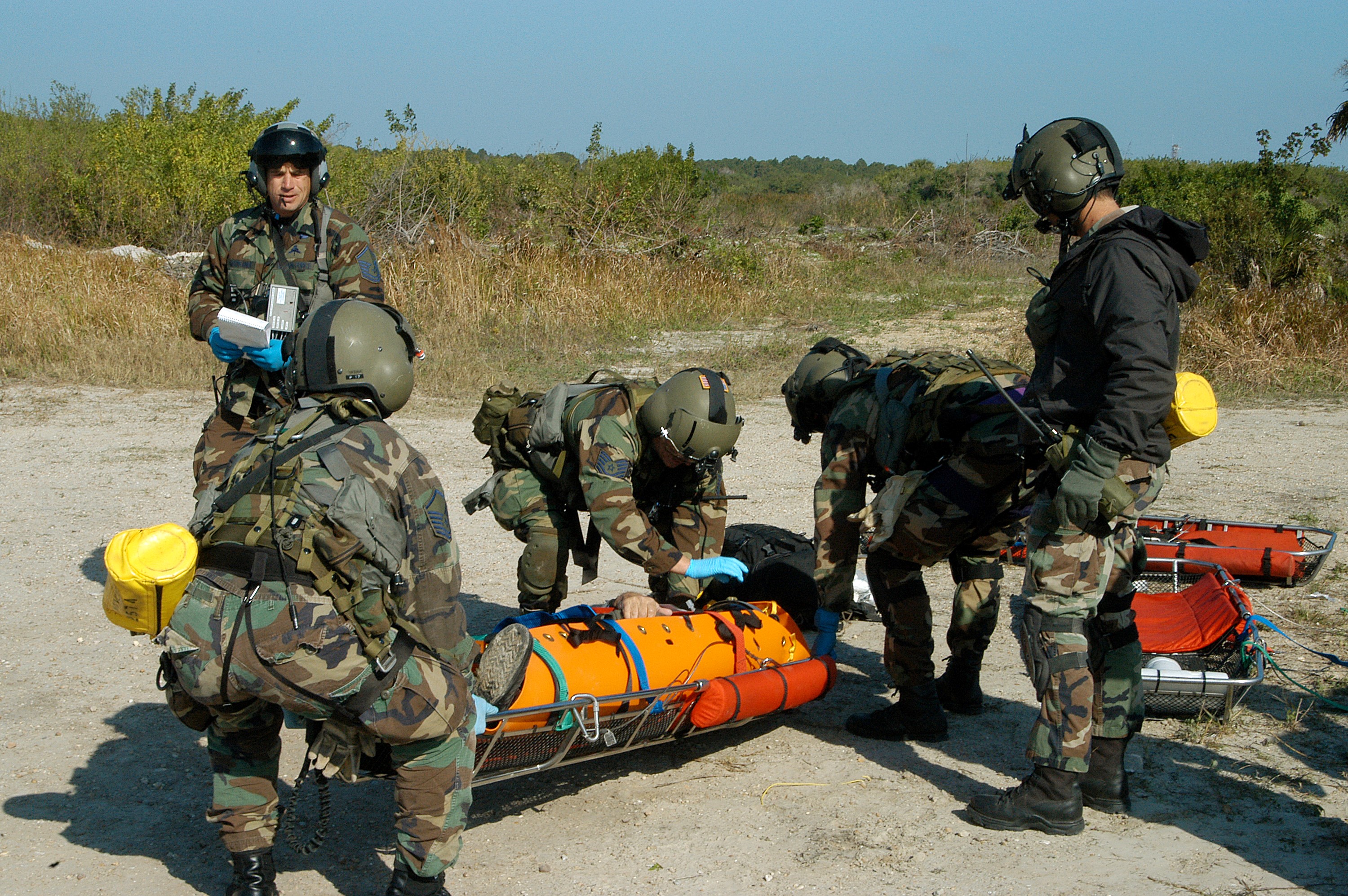 KENNEDY SPACE CENTER, FLA. - A helicopter rescue team prepares another “injured” astronaut for transportation to a local hospital. They are all taking part in a “Mode VII” emergency landing simulation at Kennedy Space Center. The purpose of the Mode VII is to exercise emergency preparedness personnel, equipment and facilities in rescuing astronauts from a downed orbiter and providing immediate medical attention. This simulation presents an orbiter that has crashed short of the Shuttle Landing Facility in a wooded area 2-1/2 miles south of Runway 33. Emergency crews are responding to the volunteer “astronauts” who are simulating various injuries inside the crew compartment mock-up. Rescuers must remove the crew, provide triage and transport to hospitals those who need further treatment. Local hospitals are participating in the exercise.