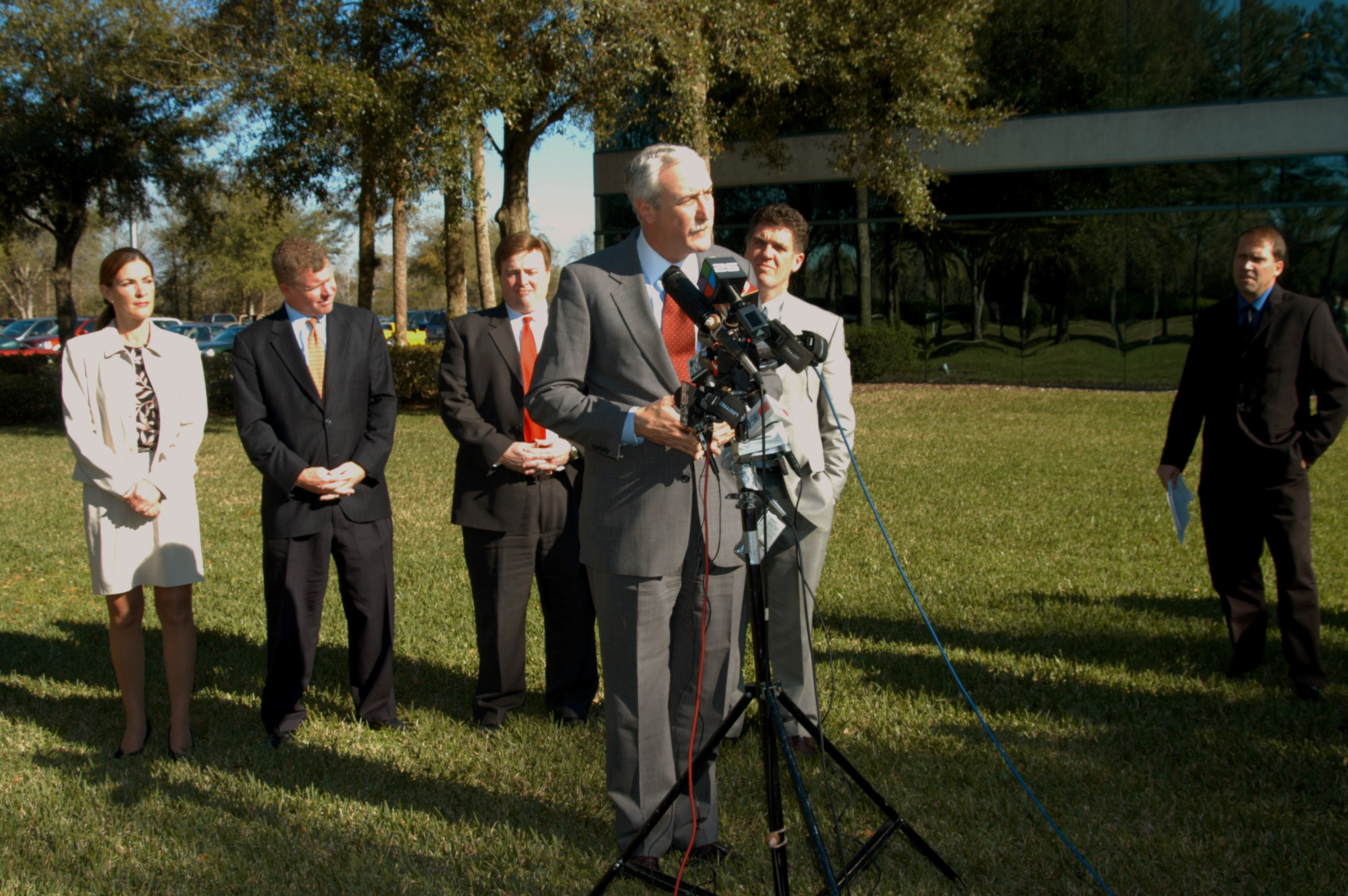 KENNEDY SPACE CENTER, FLA. - NASA Administrator Sean O’Keefe talks to the media at the Central Florida Research Park, near Orlando. He and government officials were at the park for a presentation about the assets of the research park as the site of NASA’s new Shared Services Center. Behind O’Keefe are (left to right) Pamella J. Dana, Ph.D., director, Office of Tourism, Trade, and Economic Development in Florida; Florida Congressman Tom Feeney; U.S. Representative Ric Keller; and Congressman Dave Weldon. At right is Mike Rein, division chief of KSC External Affairs. Six sites around the U.S. are under consideration for location of the Center, which would centralize NASA’s payroll, accounting, human resources, facilities and procurement offices that are now handled at each field center. The consolidation is part of the One NASA focus. Others attending the presentation included U.S. Senator Bill Nelson and Center Director Jim Kennedy.