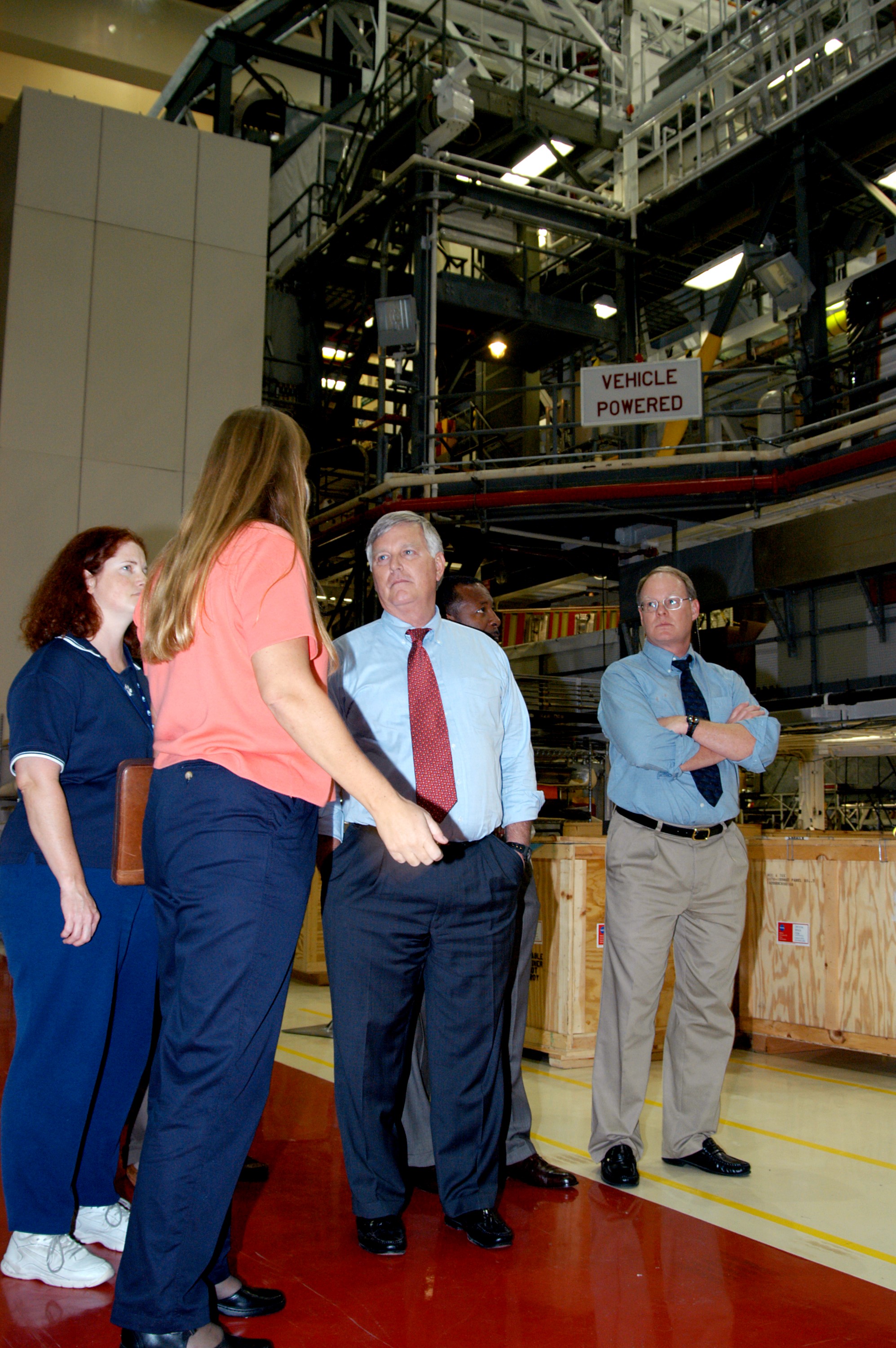 KENNEDY SPACE CENTER, FLA. - Standing near Endeavour in the Orbiter Processing Facility are (left to right) Joy Huff, with KSC Space Shuttle Processing; Kathy Laufenberg, with United Space Alliance; Center Director Jim Kennedy; and Bruce Buckingham, assistant to Deputy Director Woodrow Whitlow Jr. Kennedy and Whitlow are touring the OPF, viewing the work being done on Endeavour, which is in its Orbiter Major Modification period.
