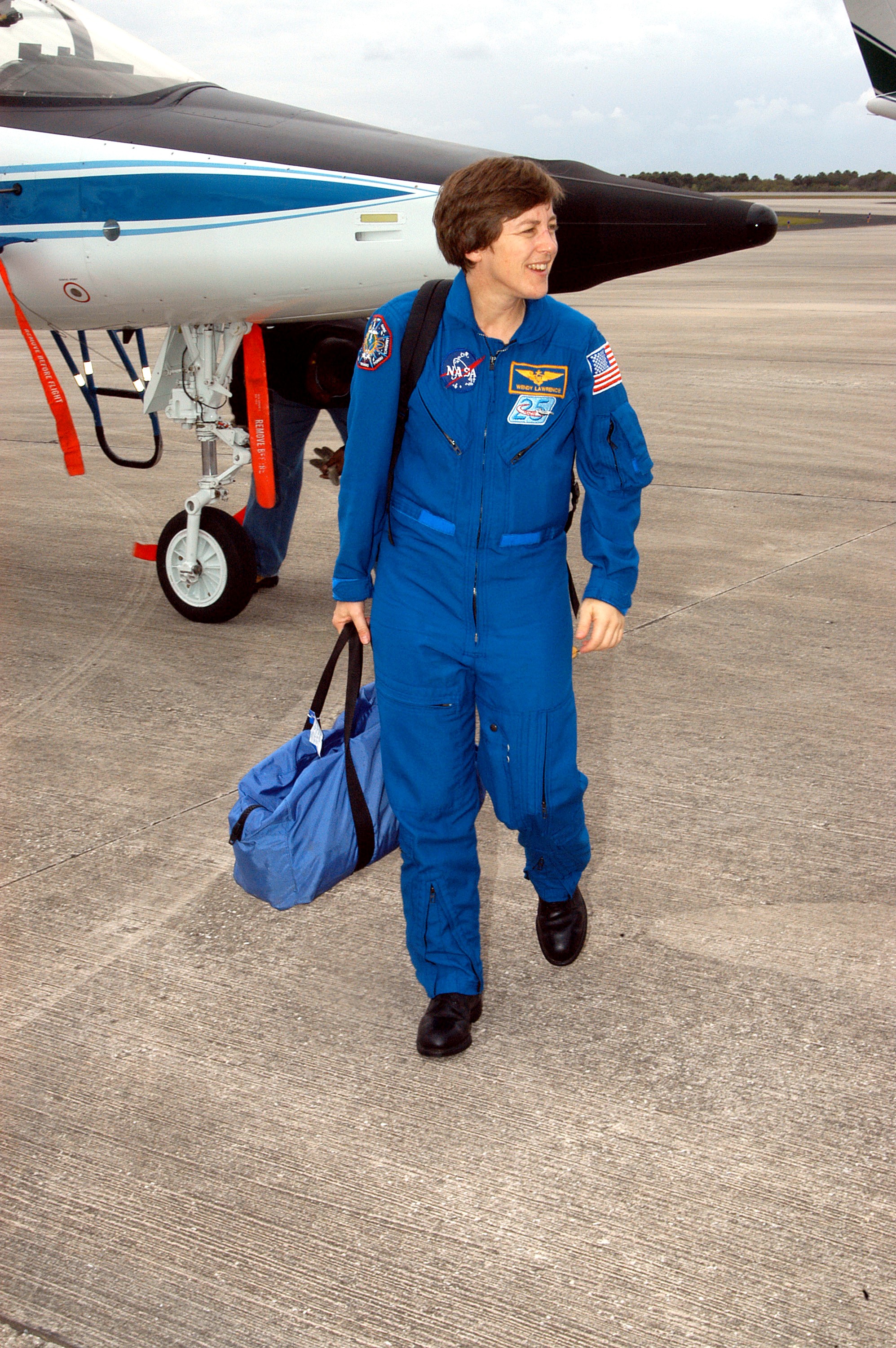 KENNEDY SPACE CENTER, FLA. - STS-114 Mission Specialist Wendy Lawrence is pleased to be back at KSC after arriving aboard a T-38 jet aircraft. She and other crew members are at the Center for familiarization activities with equipment. The mission is Logistics Flight 1, scheduled to deliver the Multi-Purpose Logistics Module carrying supplies and equipment to the Space Station and the external stowage platform.