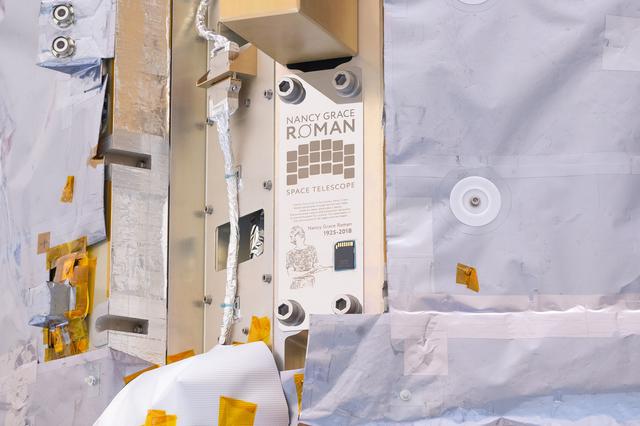 Close ups of a spacecraft in an industrial high bay.