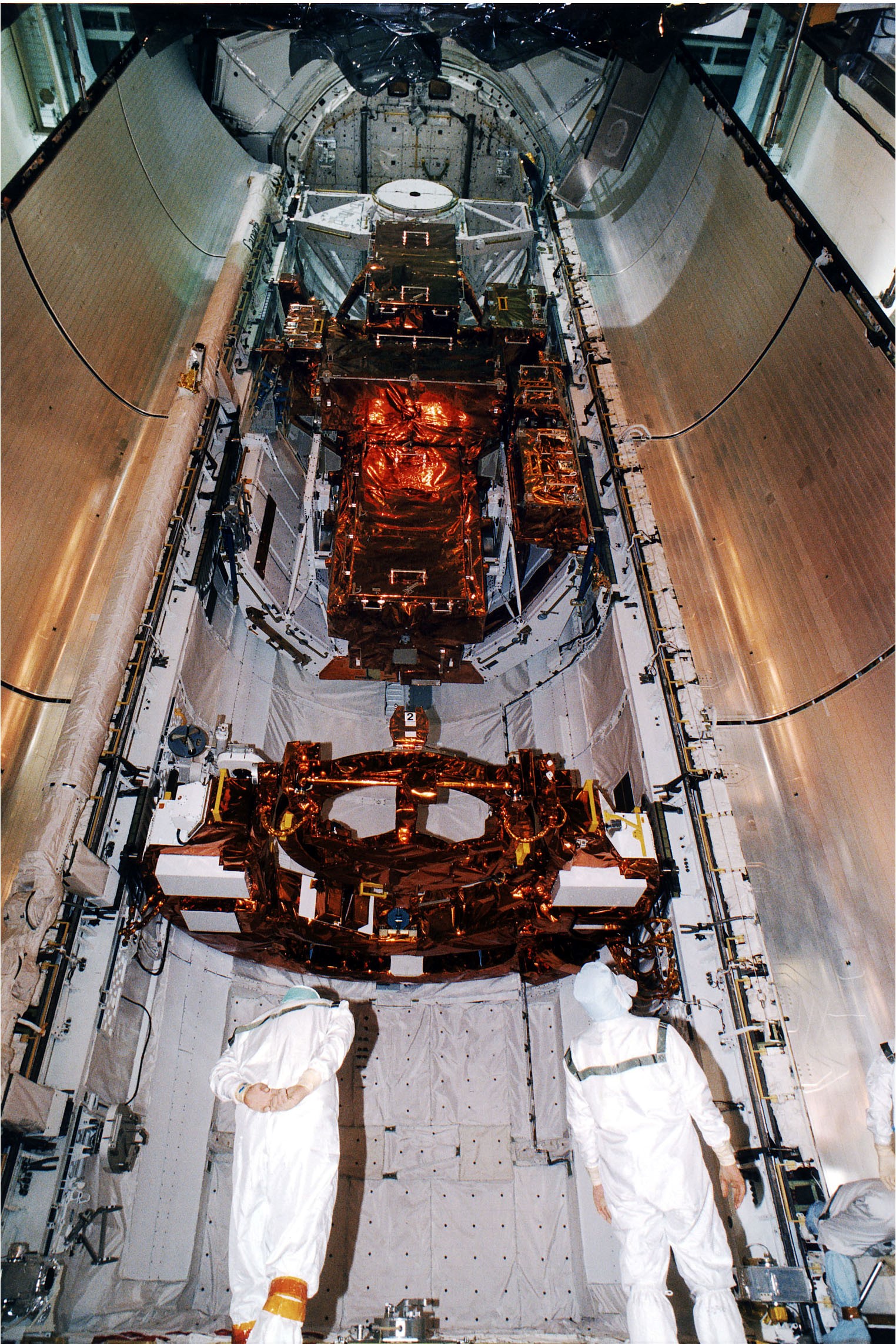 KENNEDY SPACE CENTER, FLA. - At the KSC Launch Pad 39A, two members of the payload closeout crew check equipment as the doors are just about ready to be closed. The Payload inside the bay of Discovery, the orbiter for the STS-82 mission, is ready for the launch of the second Hubble Space Telescope service mission. The payload consists of the Near Infrared Camera and Multi-Object Spectrometer (NICMOS) that will be installed, Fine Guidance Sensor #1 (FGS-1), and the Space Telescope Imaging Spectrograph (STIS) to be installed. The STS-82 will launch with a crew of seven at 3:54 a.m. EST, Feb. 11, 1997. The launch window is 65 minutes in duration. The Mission Commander for STS-82 is Ken Bowersox. The purpose of the mission is to upgrade the scientific capabilities, service or replace aging components on the Telescope and provide a reboost to the optimum altitude.