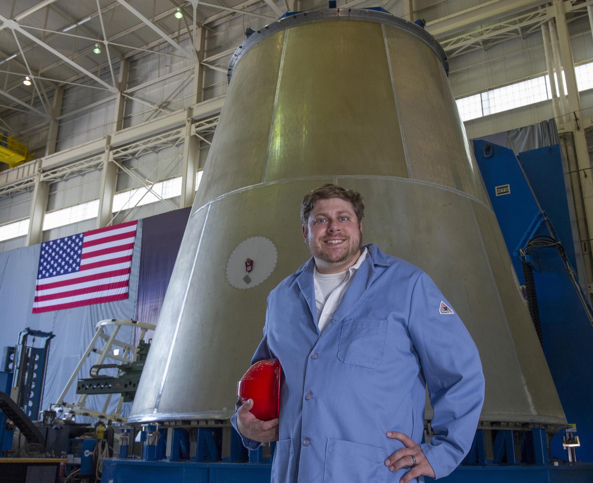 MARSHALL WELD ENGINEER JUSTIN LITTELL POSES WITH LAUNCH VEHICLE