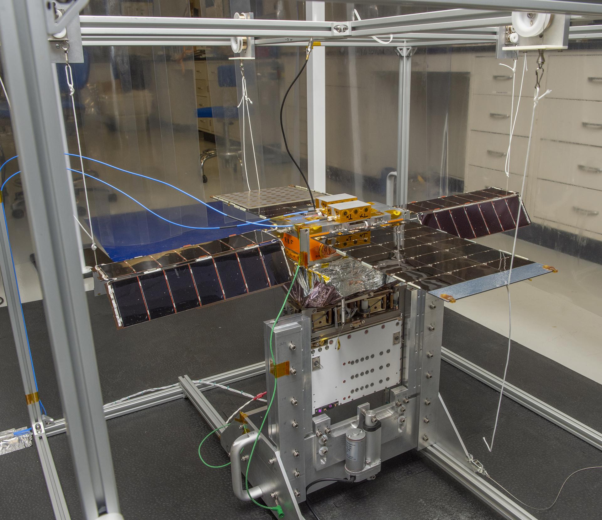 Spacecraft in Gravity Off-load Fixture (GOLF), System Test configuration - Arisa Waddle – Test Engineer, Rick Wilson – Lead Test Engineer