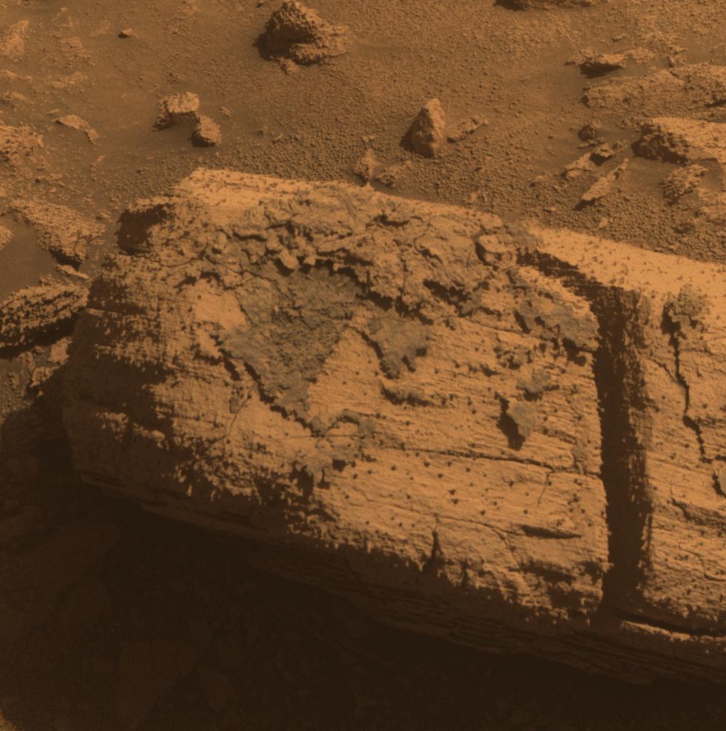 Rock with Odd Coating Beside a Young Martian Crater