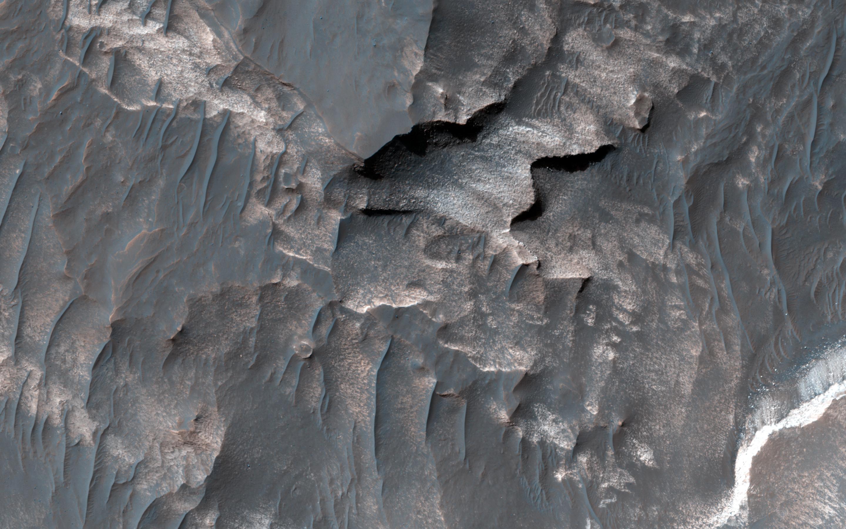 Light-Toned Deposits along Coprates Chasma Slopes