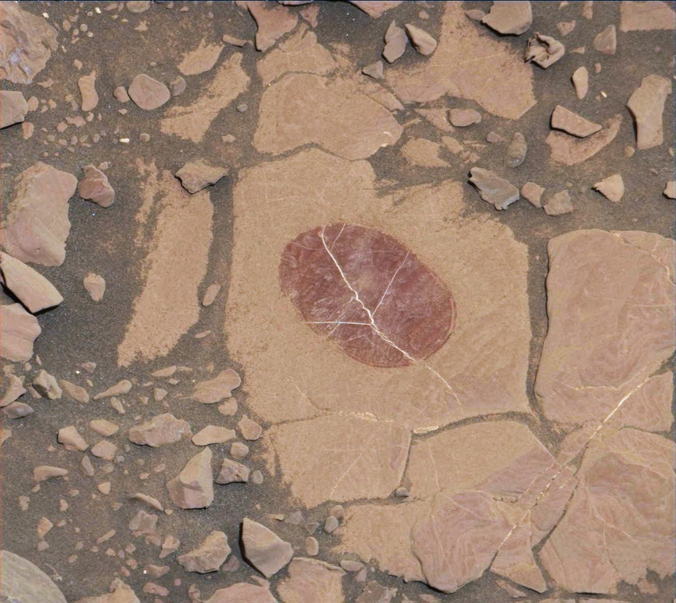 Curiosity Checks Under the Dust on a Martian Rock