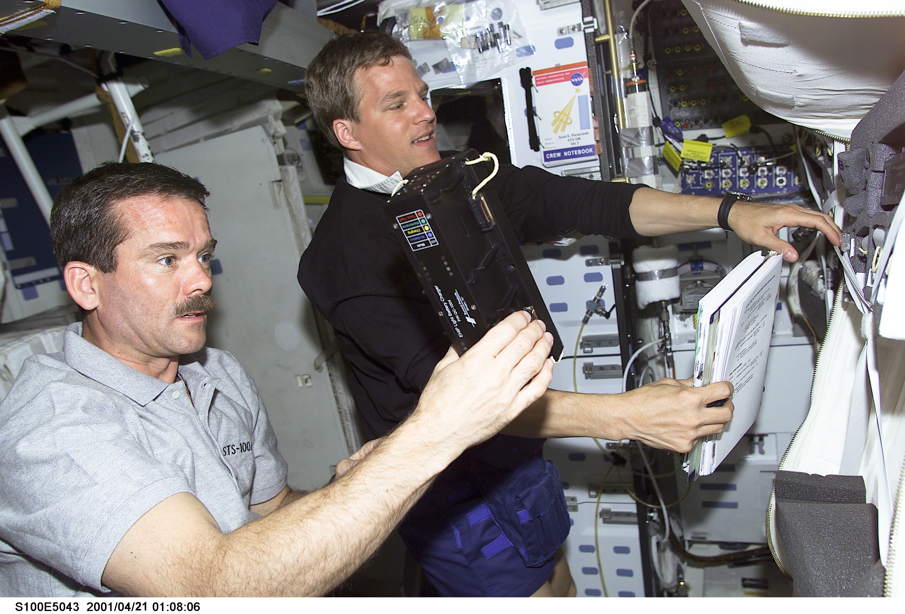 MS Parazynski and MS Hadfield work on the middeck of Endeavour
