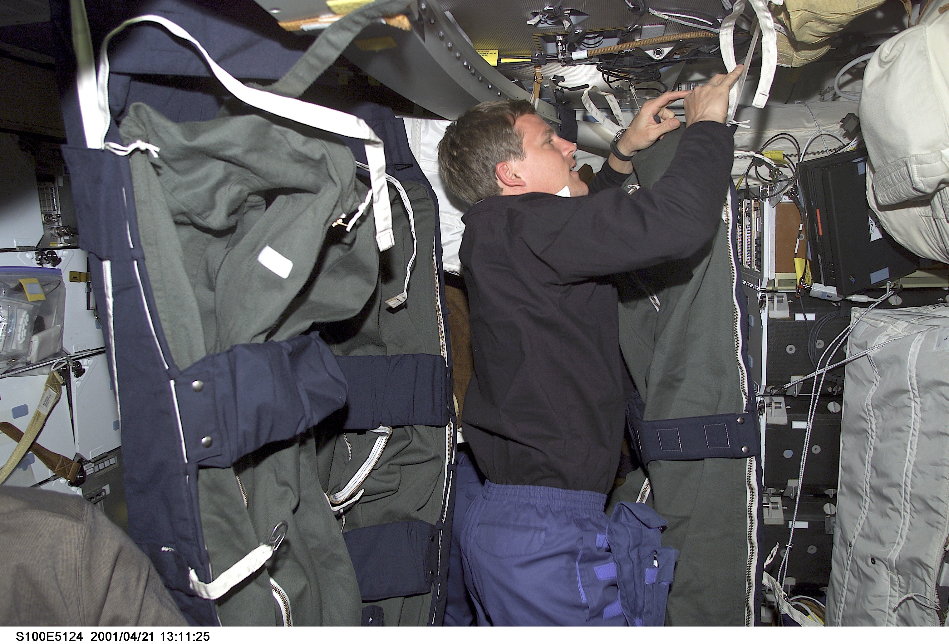 MS Parazynski looks through a stowage bag on the middeck of Endeavour