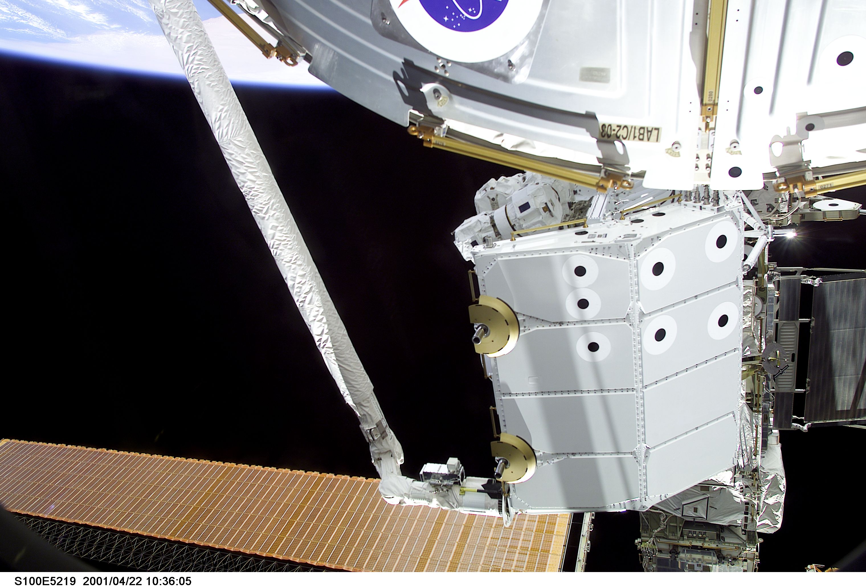 View of the RMS grappling the Spacelab Pallet during STS-100