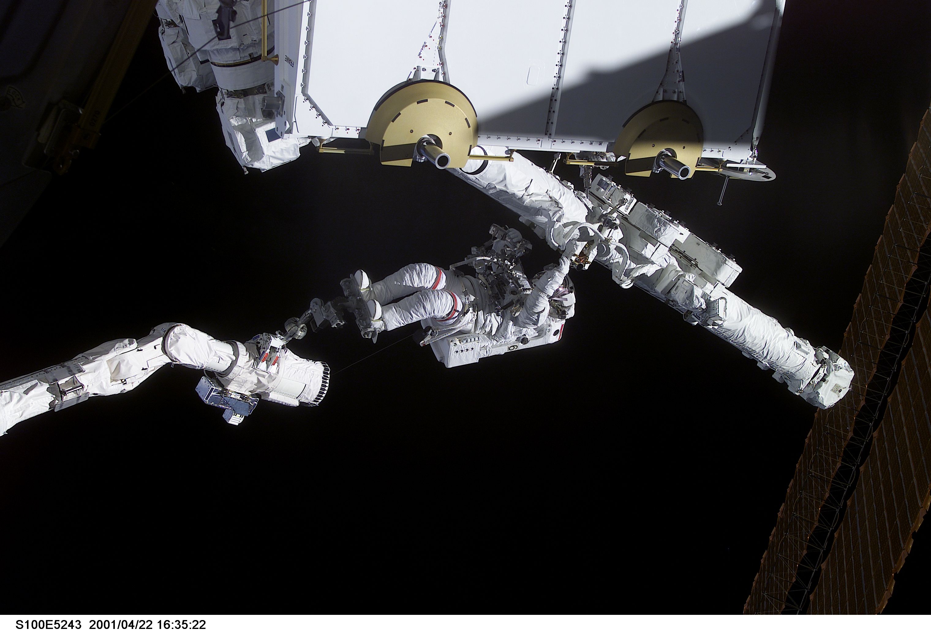 MS Hadfield works on the SSRMS in the SLP during the first EVA for STS-100