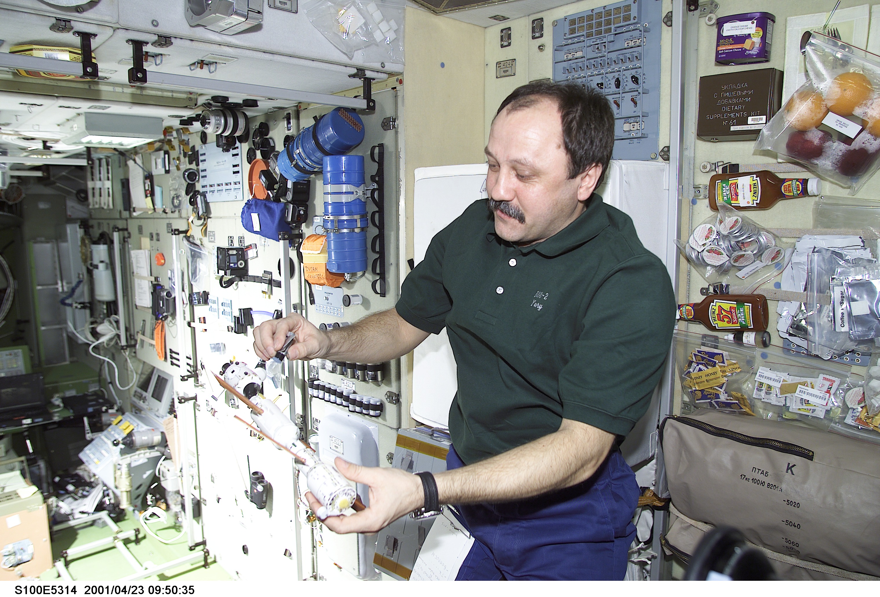 Usachev explains the Russian segments of the ISS in Zvezda during STS-100's ingress