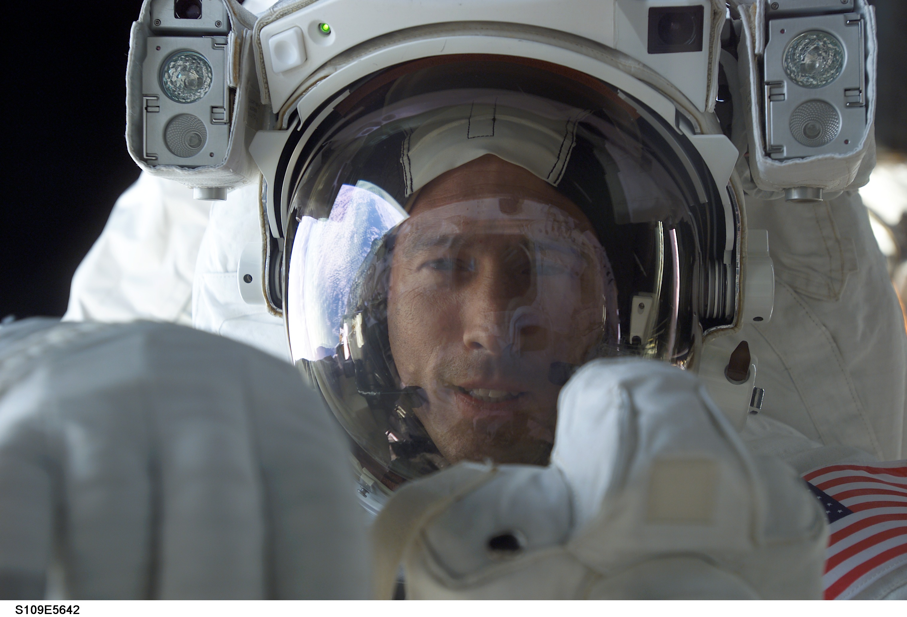 EVA 2 - MS Newman with camera