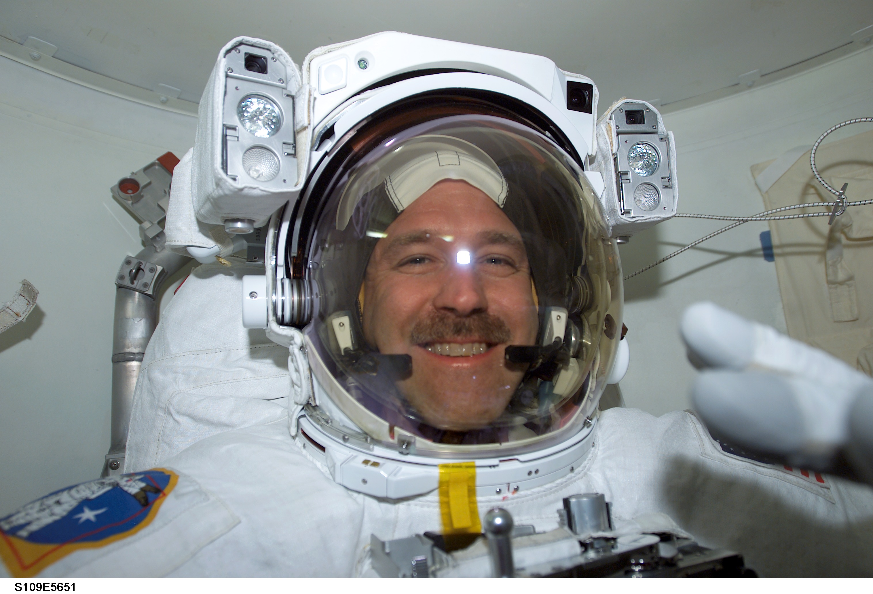 MS Grunsfeld wearing EMU in airlock prepares for EVA 3