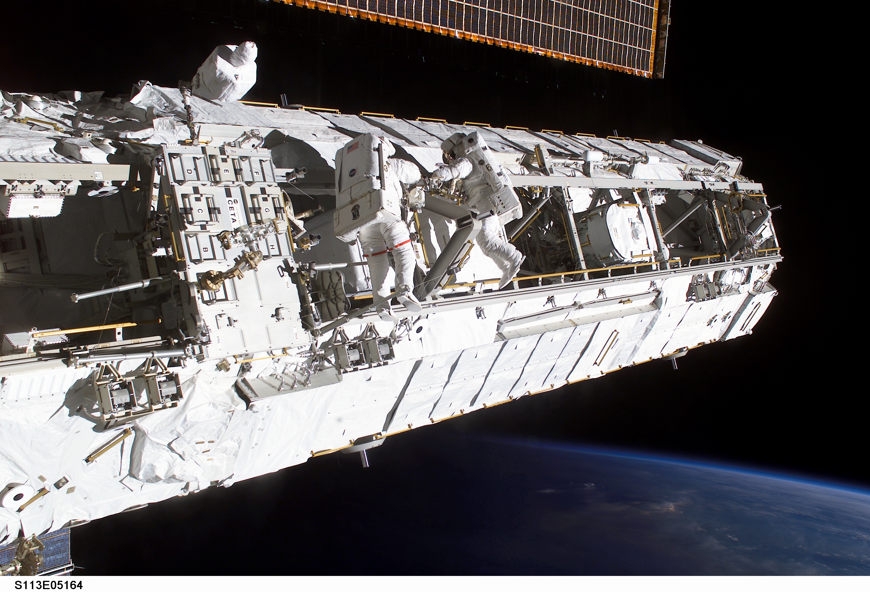 MS Lopez-Alegria and MS Herrington Keel Trunnion Pin OPS on P1 Truss during second EVA for STS-113