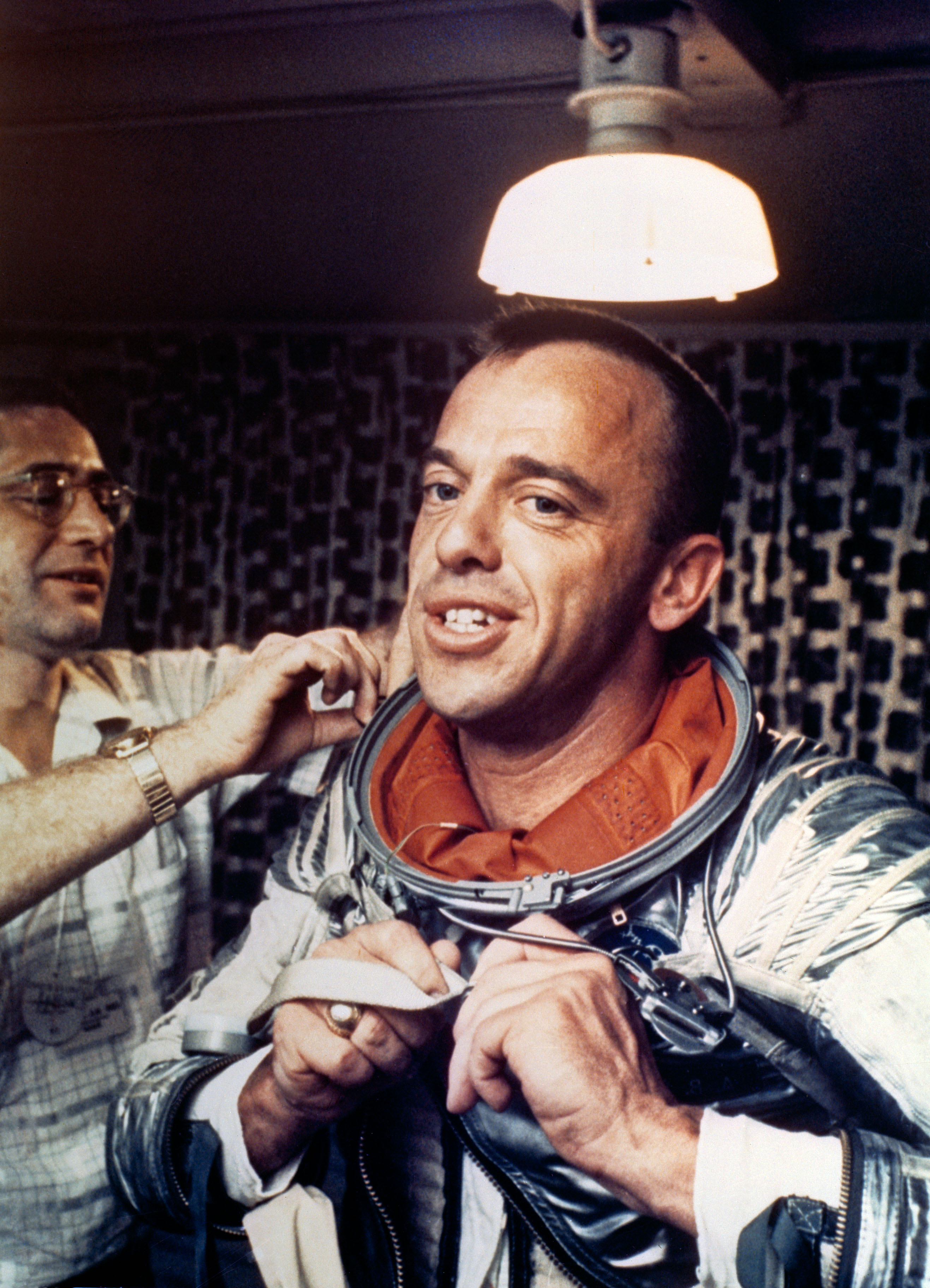 Astronaut Alan Shepard removing space suit on U.S. Champlain after recovery