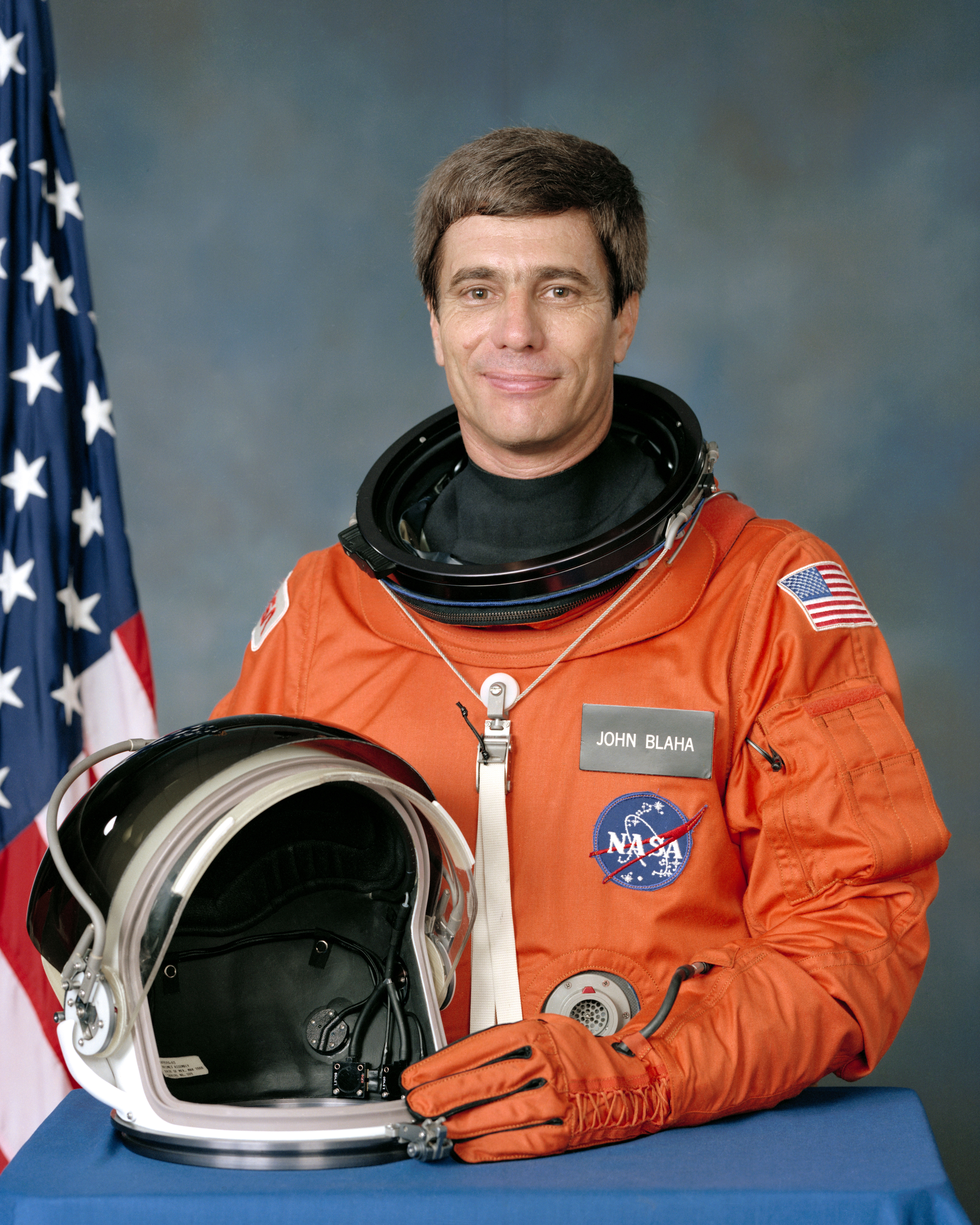 Official NASA portrait of STS-29 Astronaut John Blaha in the orange partial
