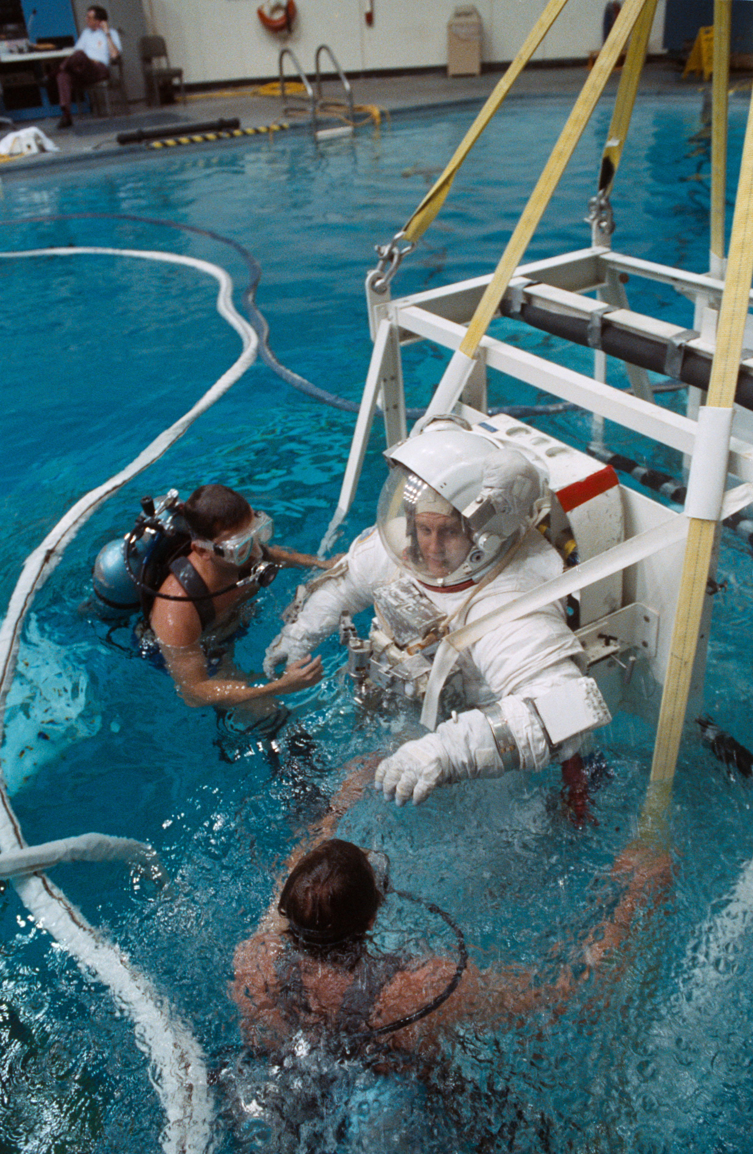 STS-48 MS Buchli, in EMU, is lowered into JSC's WETF pool for EVA simulation