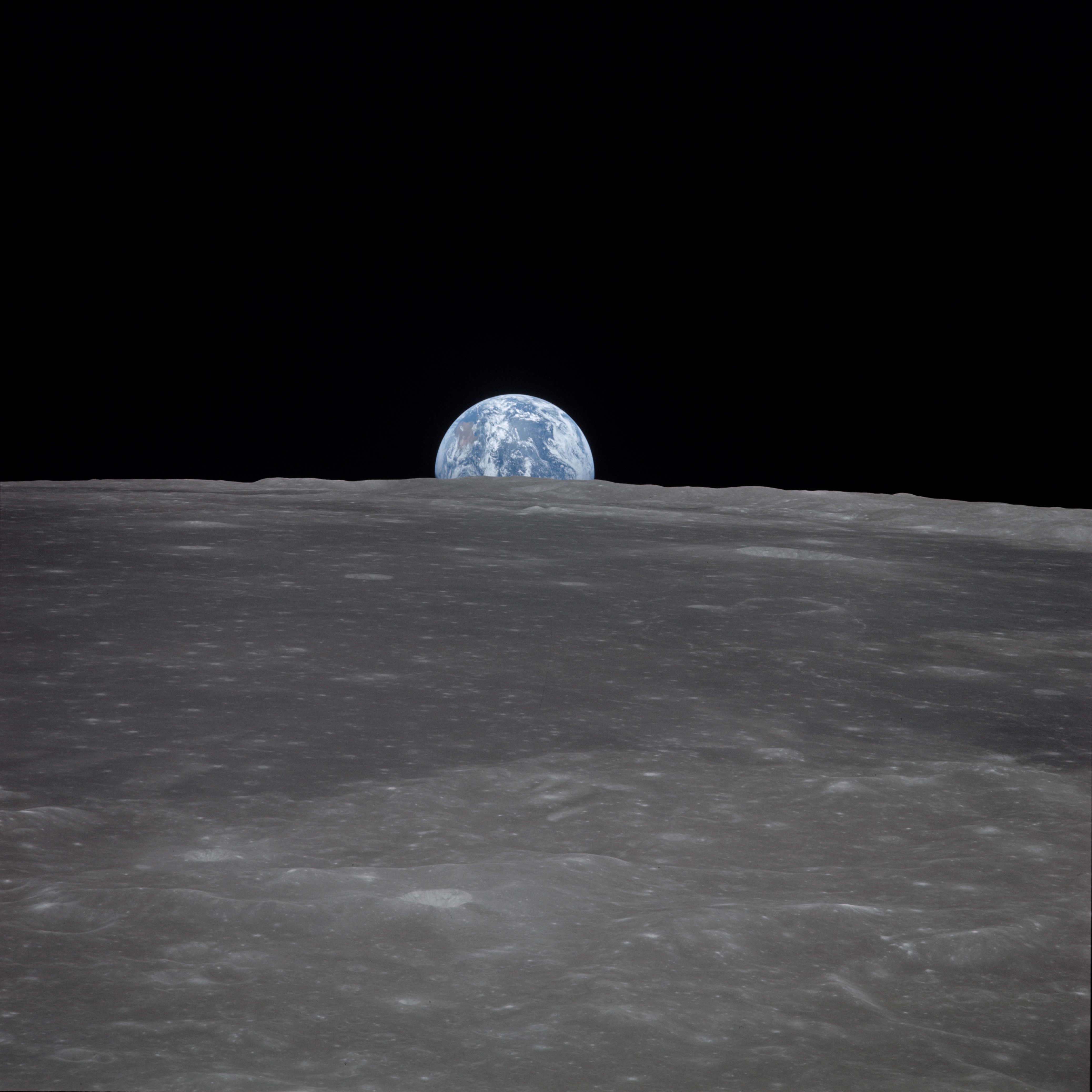 Apollo 11 Mission image - View of moon limb,with Earth on the horizon,Mare Smythii Region