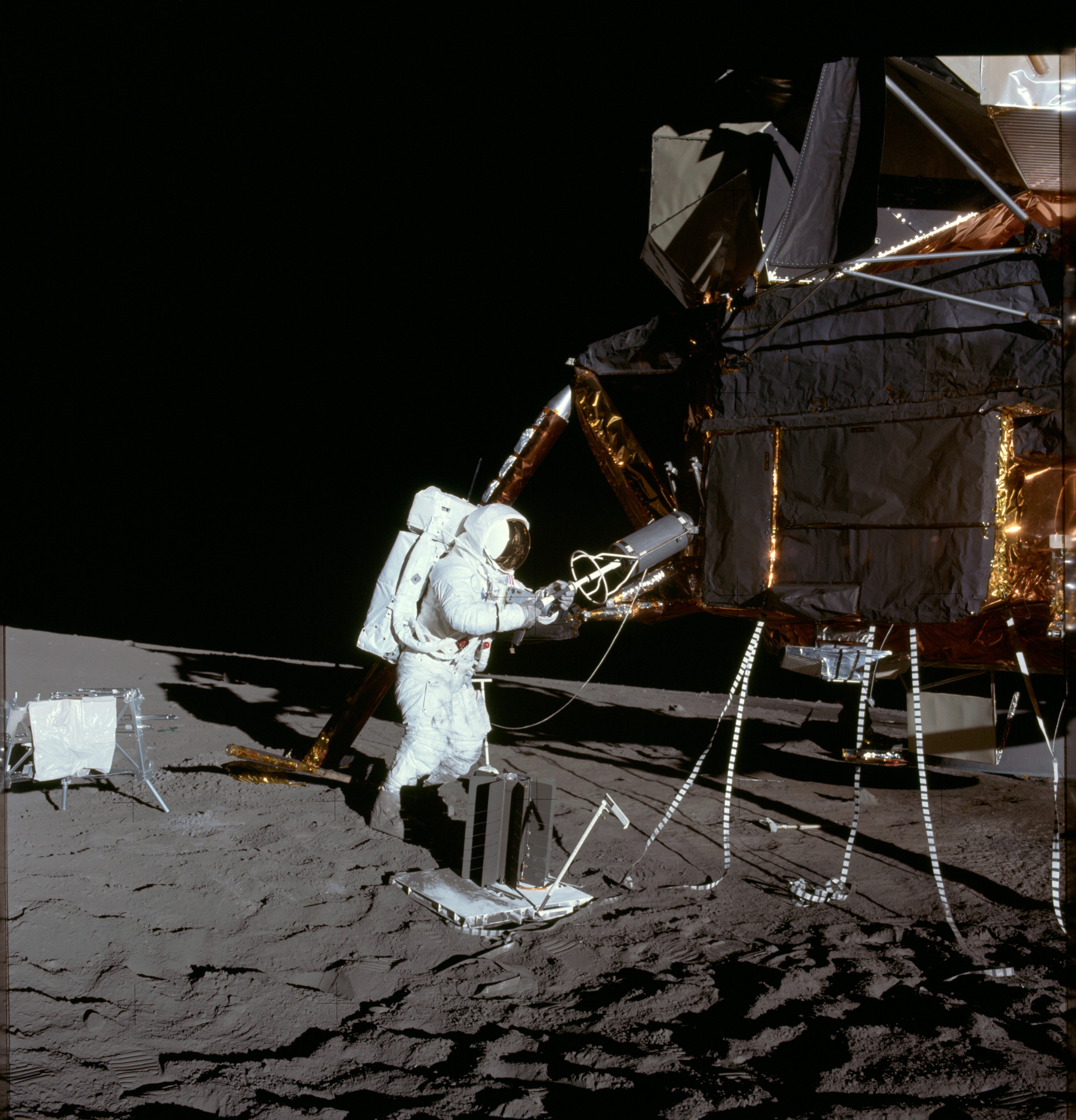 Apollo 12 Mission image - Alan Bean unloads ALSEP RTG fuel element