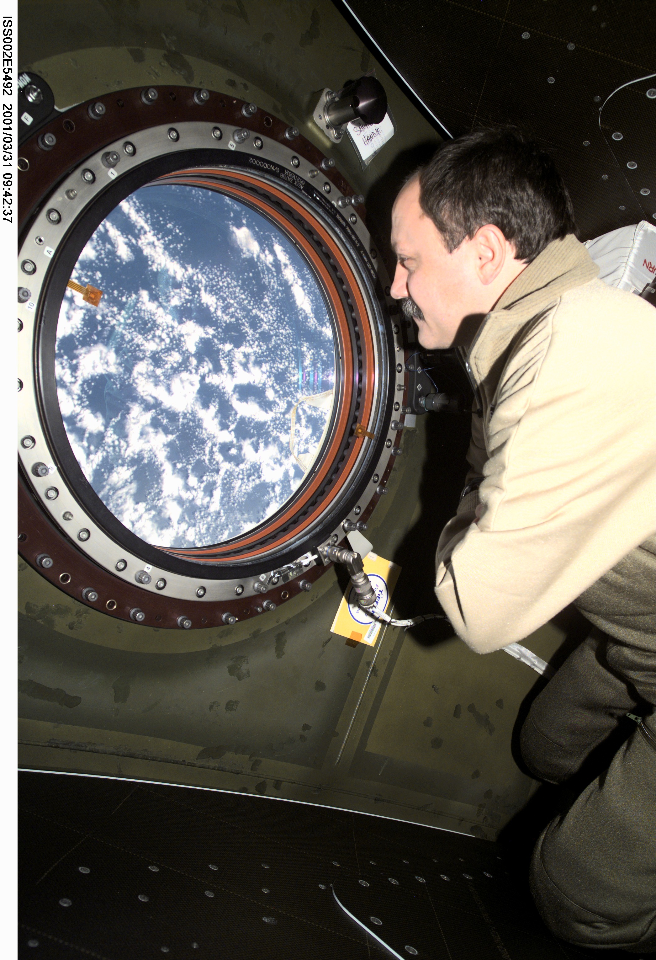 View of Usachev at photo quality window in Destiny Laboratory module