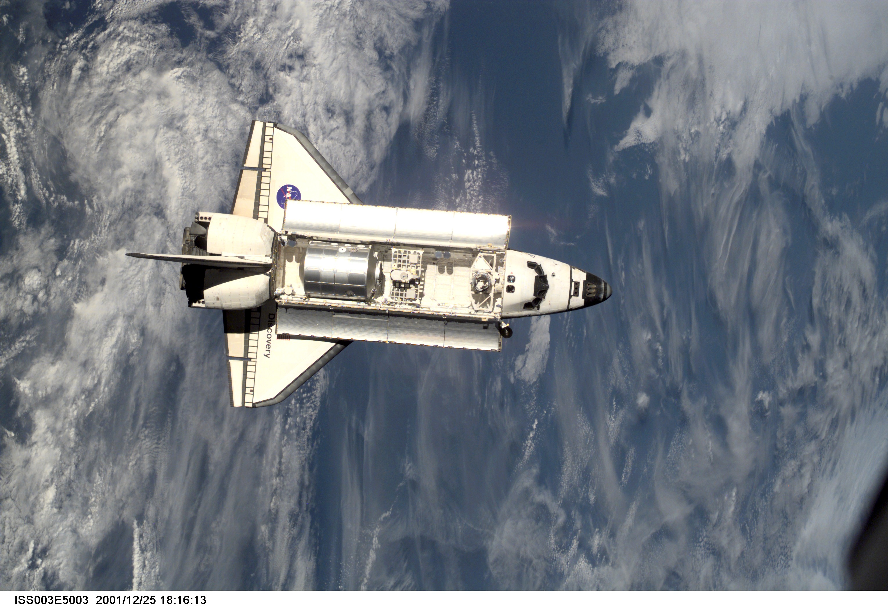 View of Discovery approaching the ISS for docking during the STS-105 mission