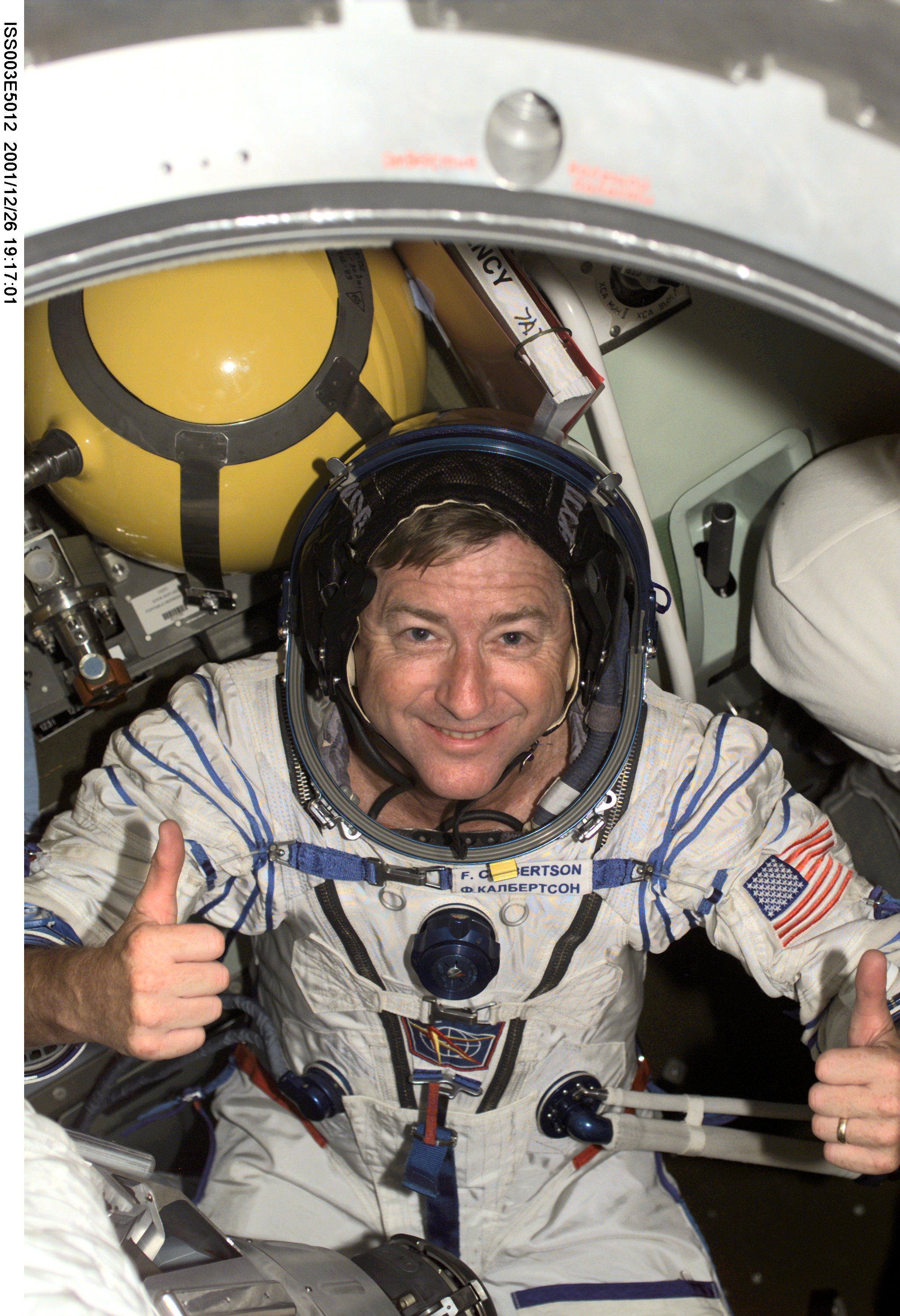 Frank Culbertson poses in the Soyuz Spacecraft during Expedition Three