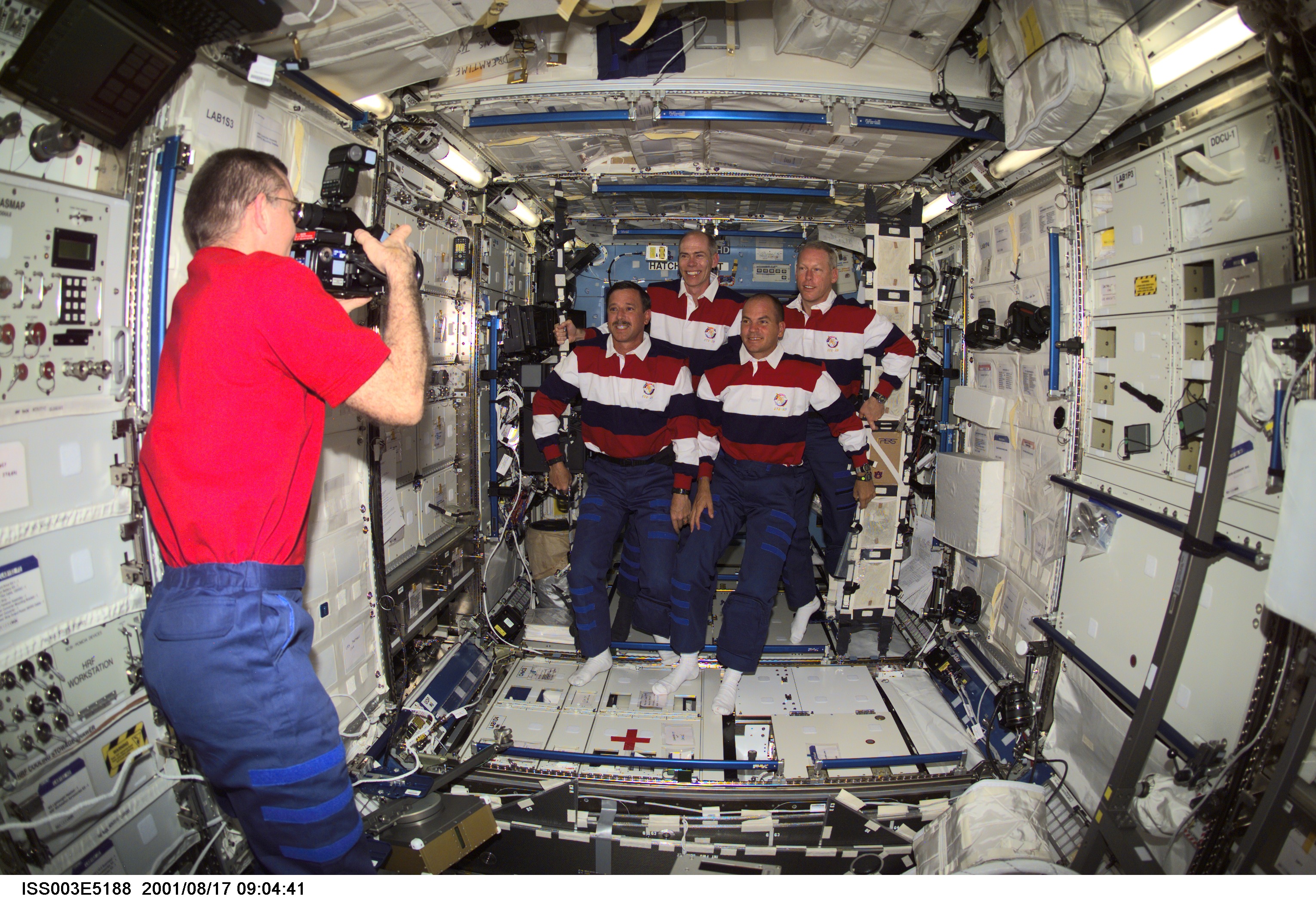 Voss videotapes the STS-105 crewmembers in the U.S. Laboratory