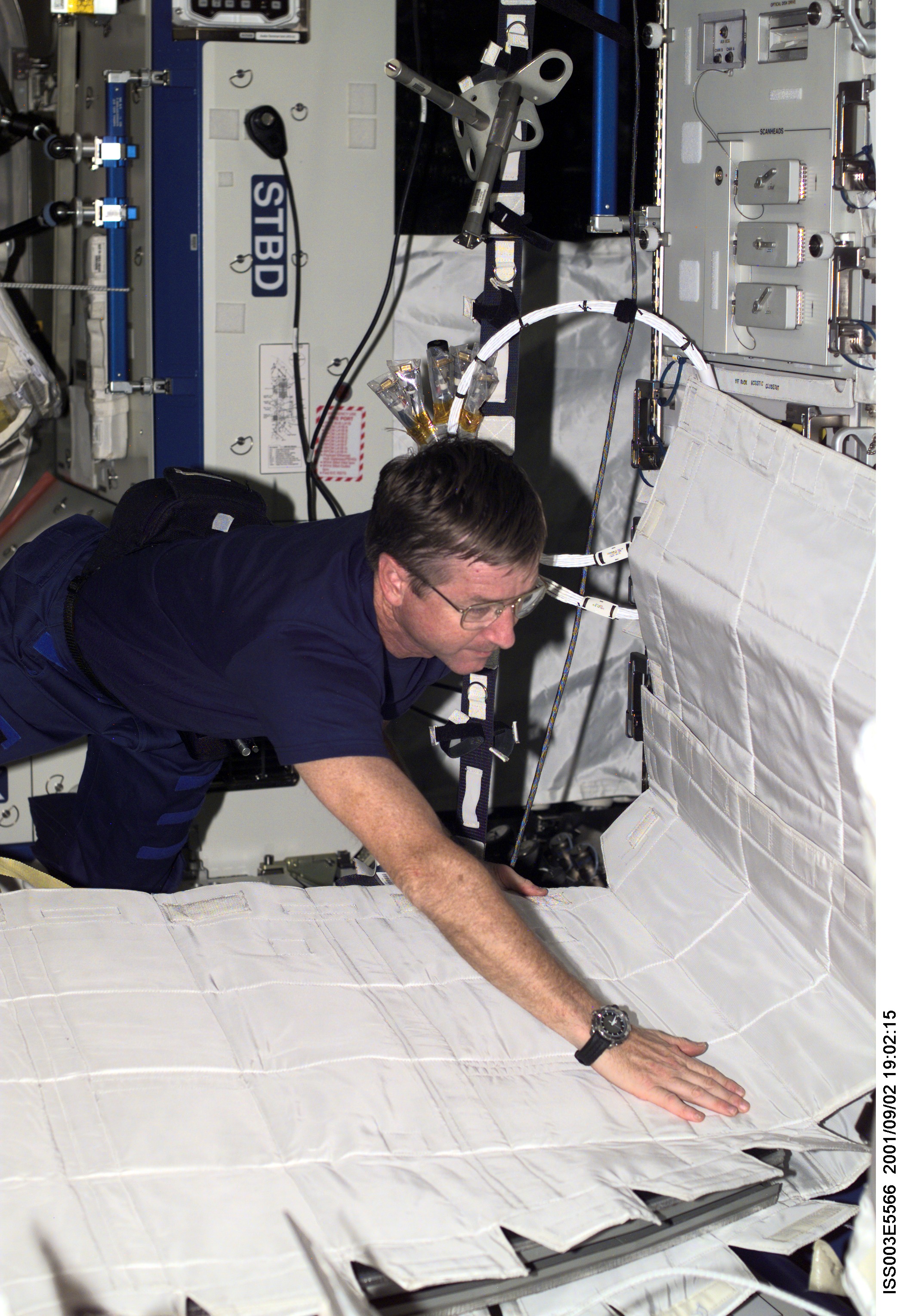 Culbertson sets up the Temporary Sleep Station (TESS) in Destiny during Expedition Three