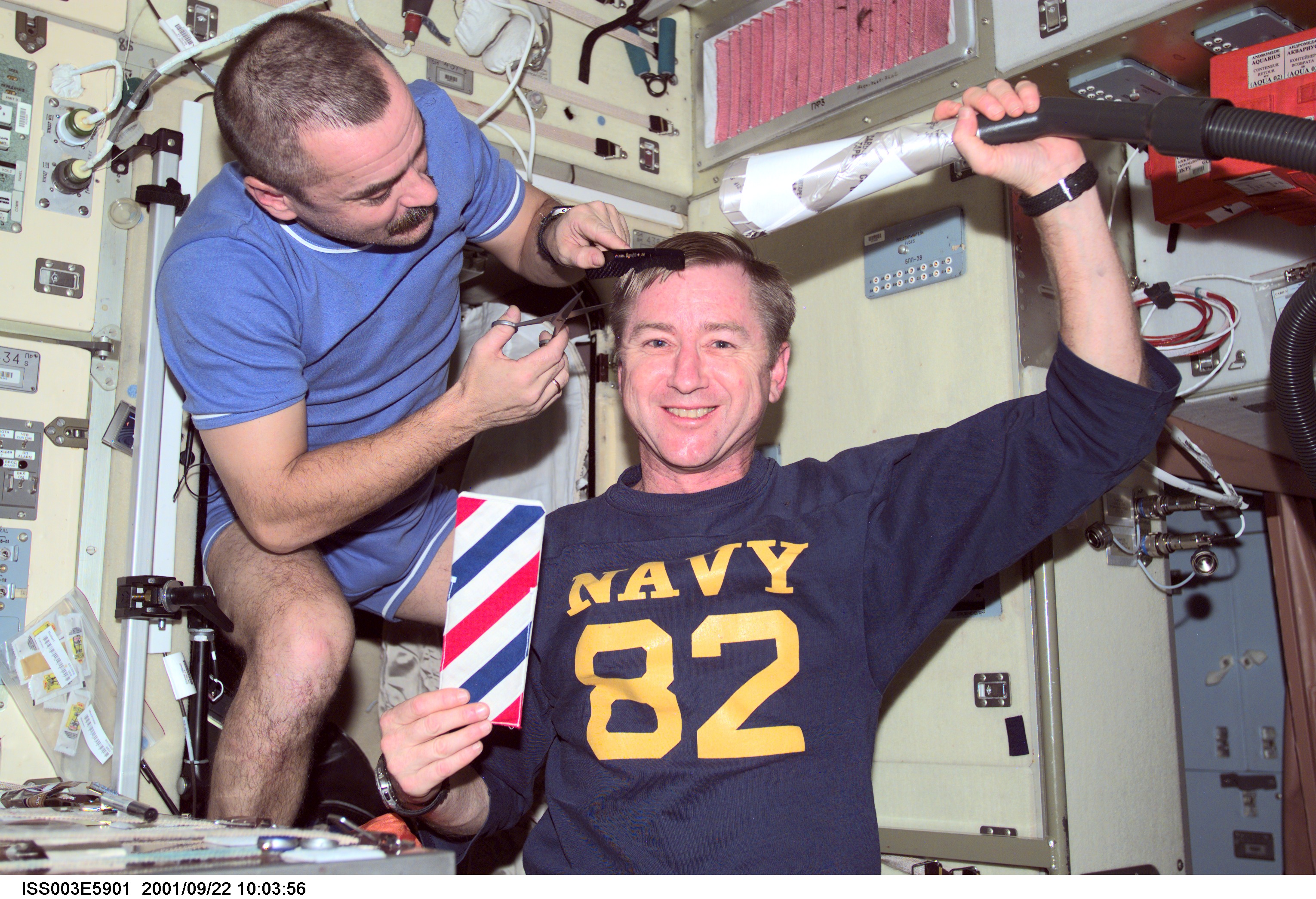 Tyurin gives Culbertson a haircut in the Service Module during Expedition Three