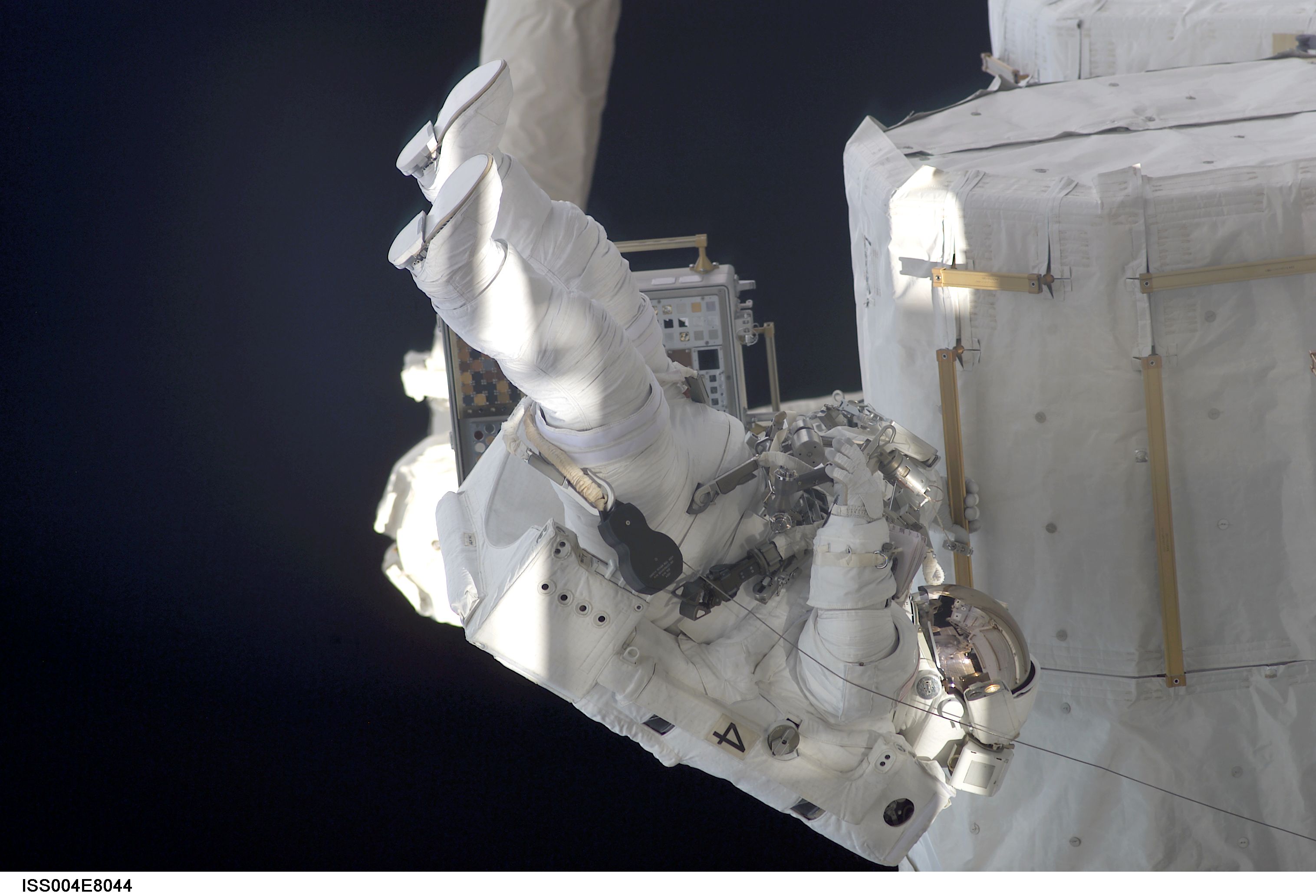 Bursch on outside of Quest Airlock during EVA 3, Expedition Four