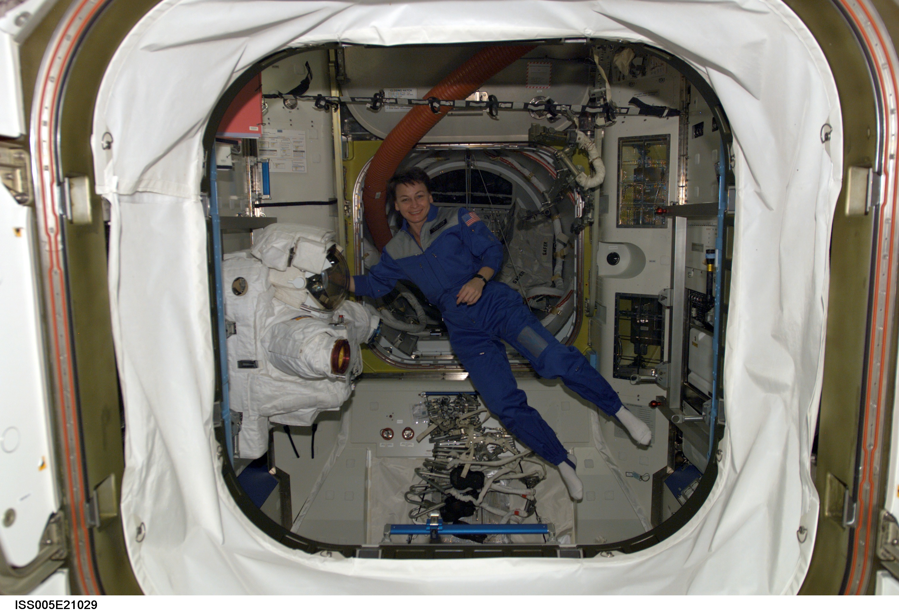 Astronaut Peggy Whitson floats in the Quest/Airlock during Expedition Five on the ISS