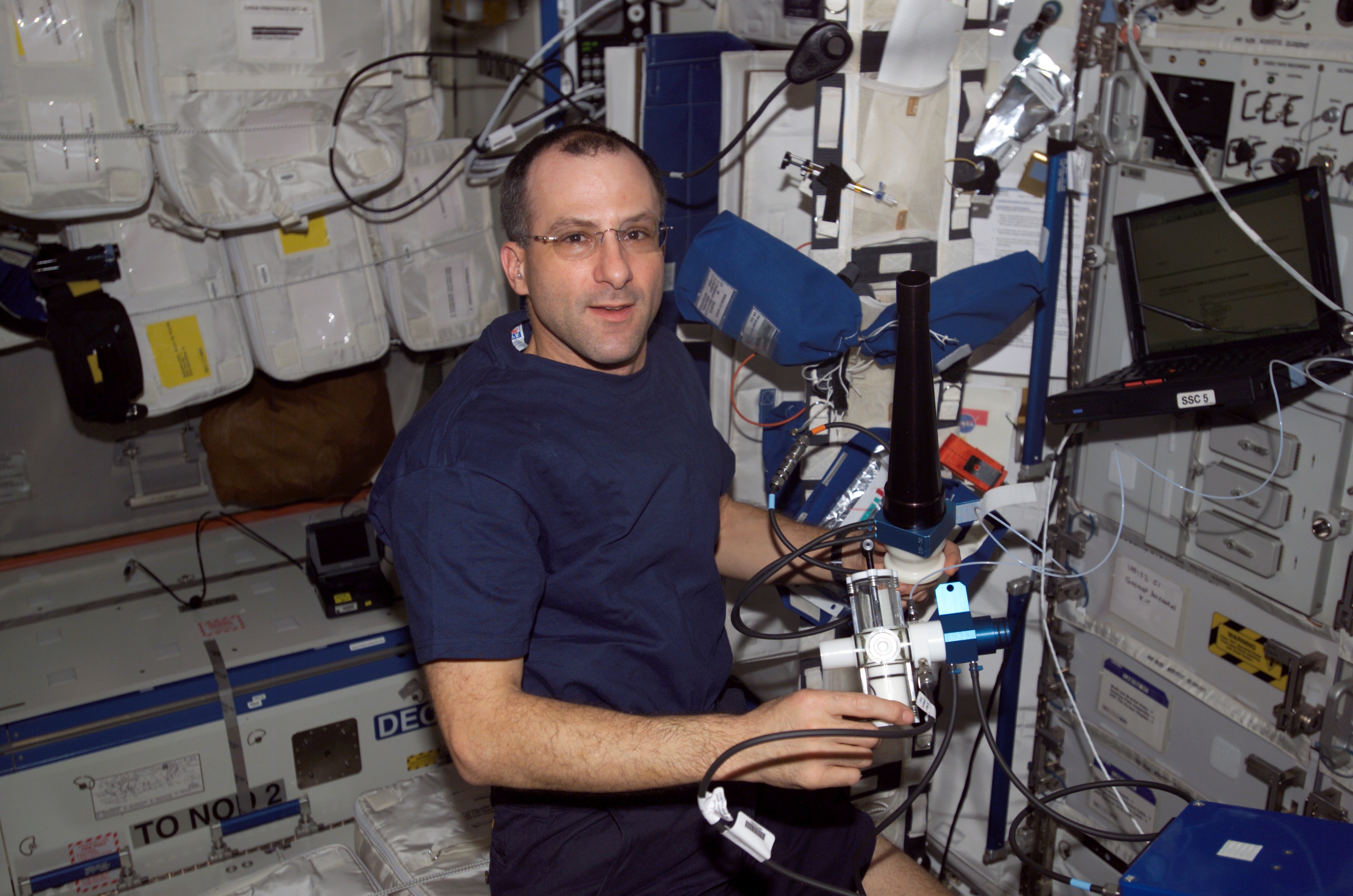 Expedition Six Flight Engineer Donald R. Pettit is loading software on PC in U.S. Lab