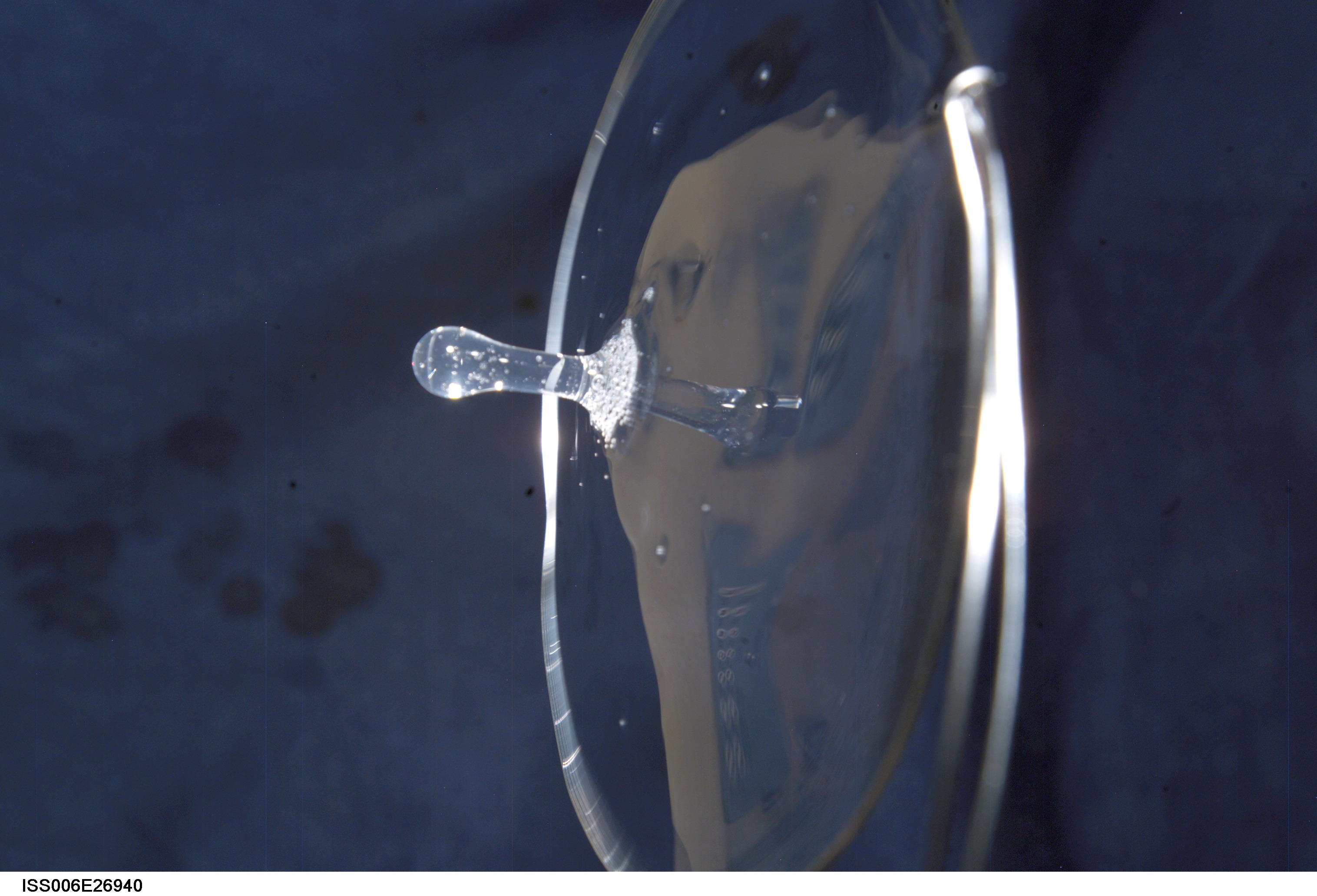 View of a surface tension demonstration using water that is being held in place by a 50mm metal loop