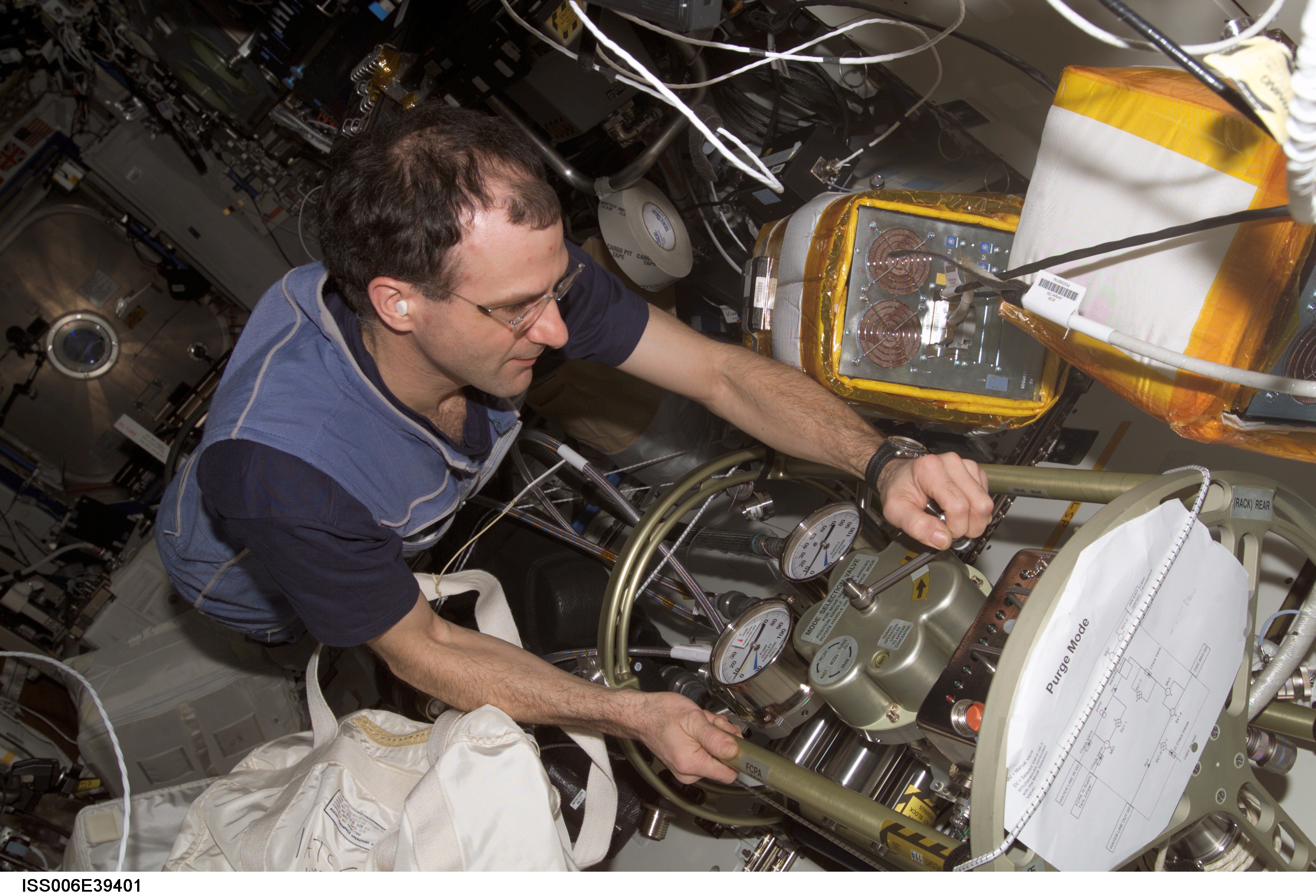 Flight Engineer Donald R. Pettit making a valve adjustment to the FCPA