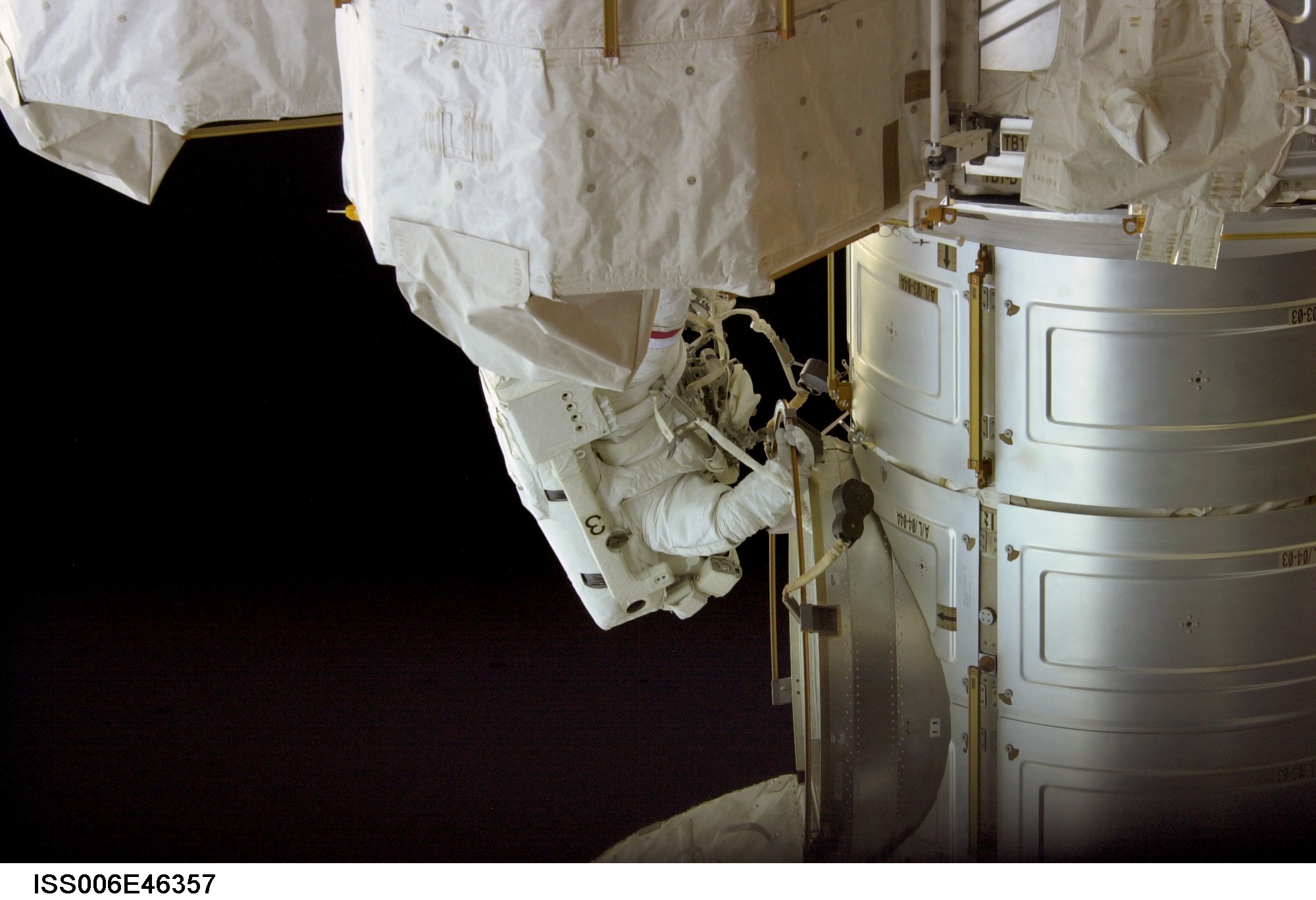 View of Commander Kenneth D. Bowersox outside the Airlock performing a variety of tasks