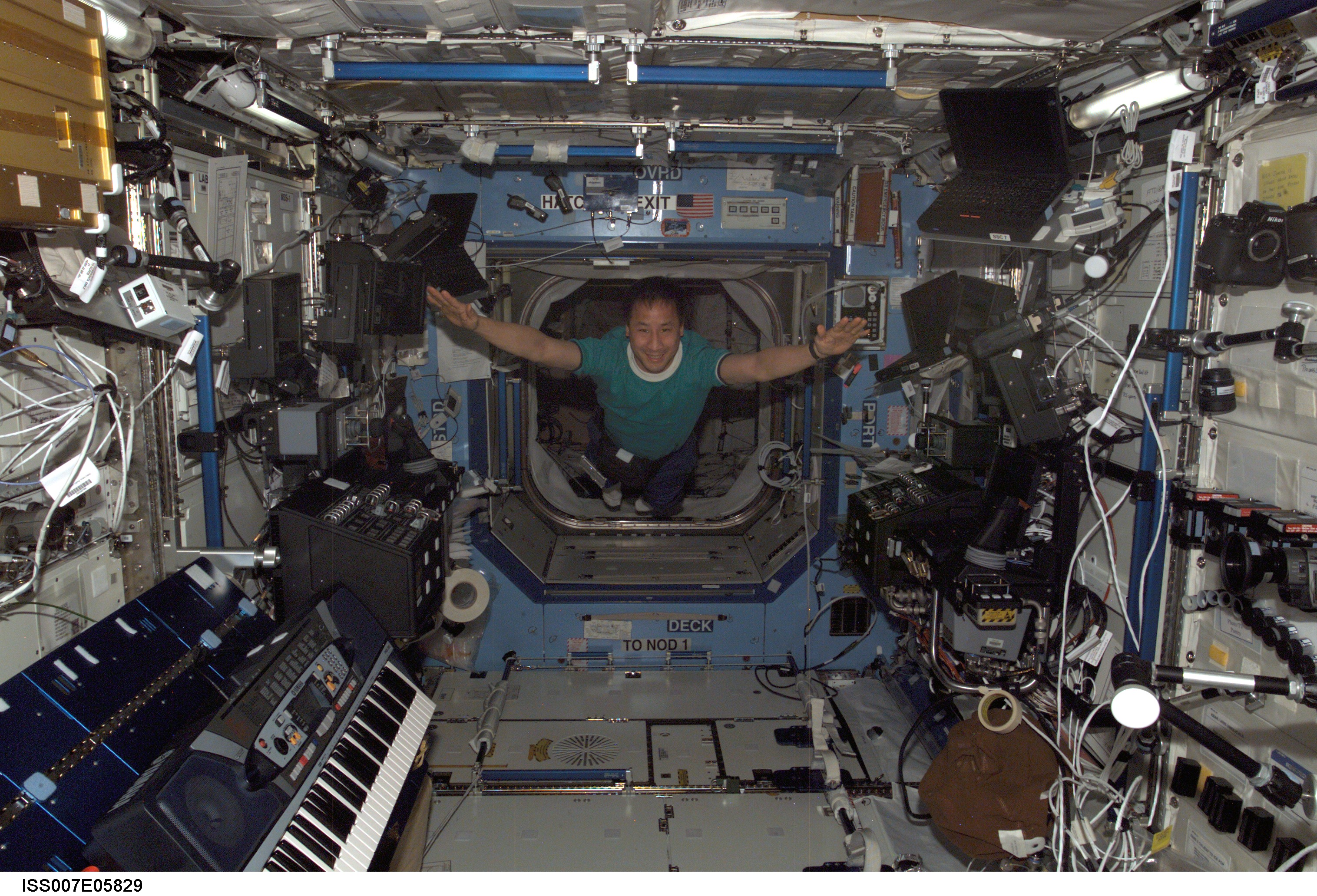 Expedition Seven Science Officer Ed Lu flies through the Destiny laboratory