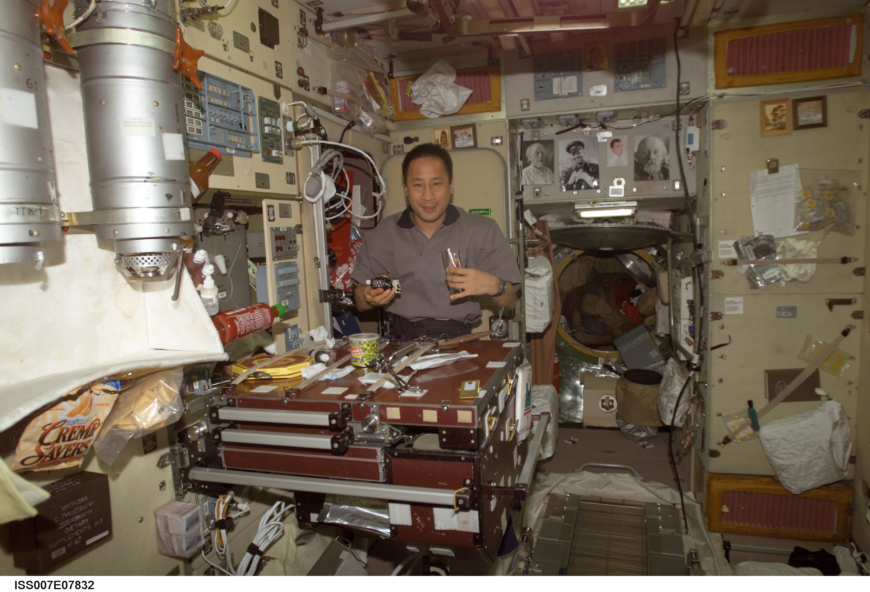 Expedition Seven Science Officer Lu with food packets in Zvezda module