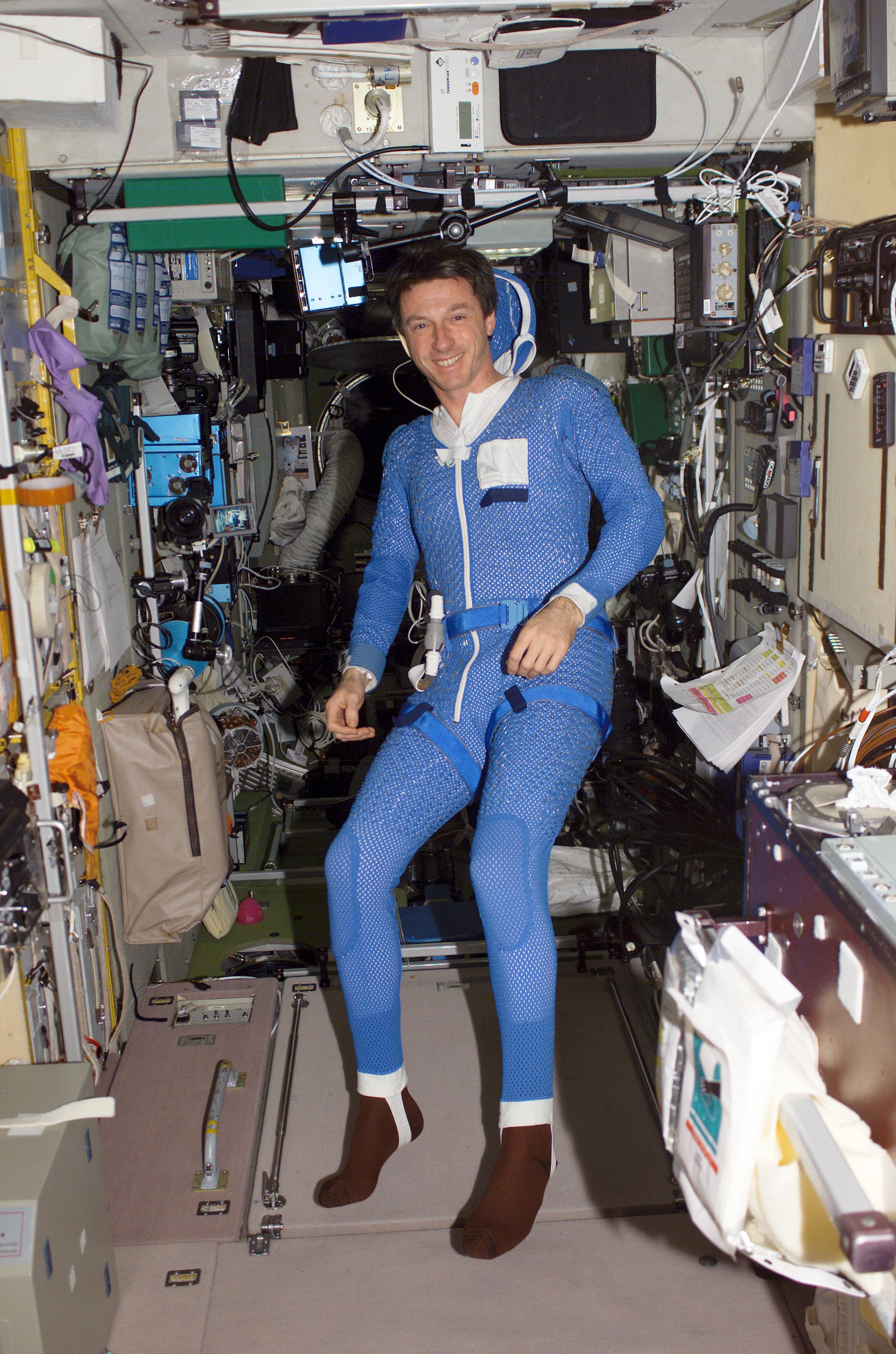 Foale, in SM, suited in blue thermal garment prior to EVA during Expedition 8