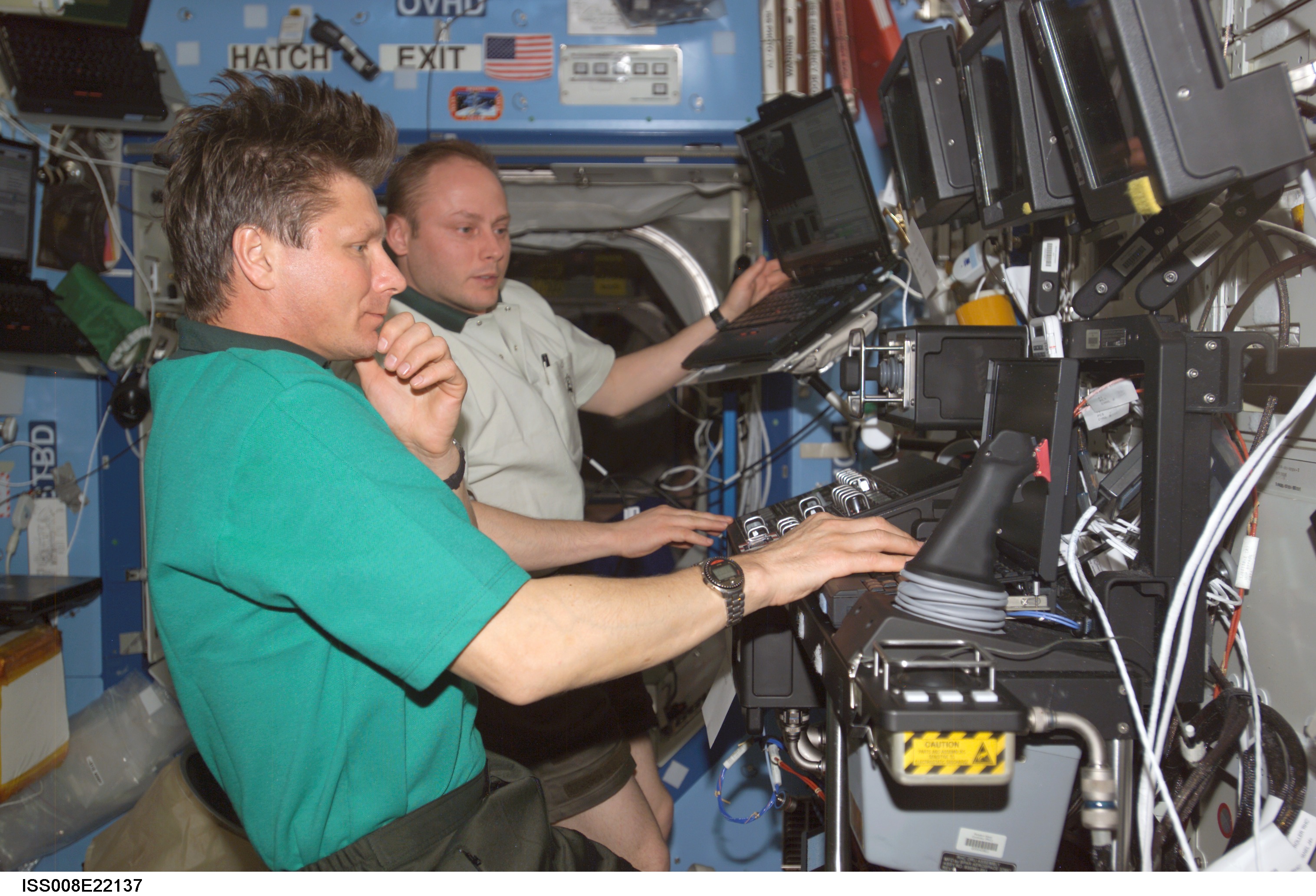 Padalka and Fincke work at the SSRMS controls in the U.S. Lab during EXP 8 / EXP 9