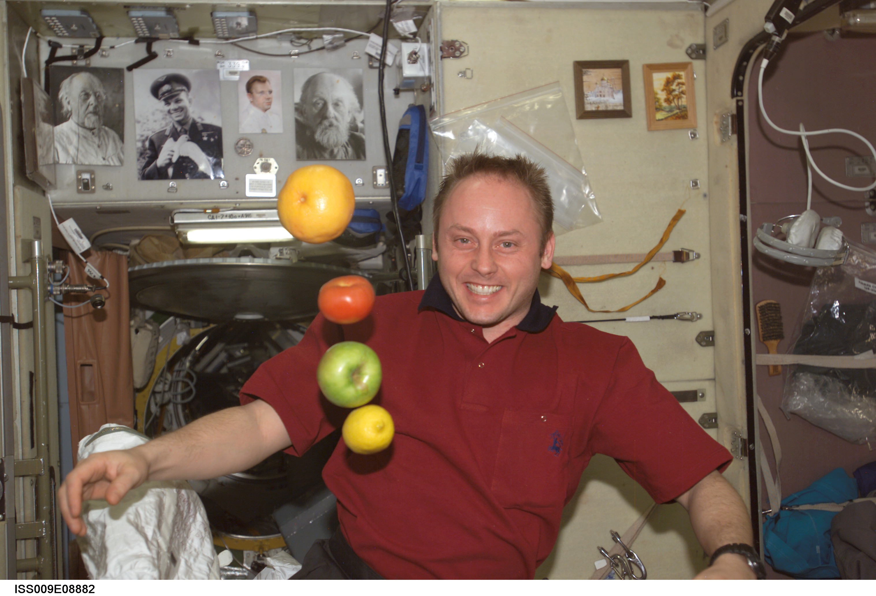Fincke watches as fruit floats in the Service Module during Expedition 9